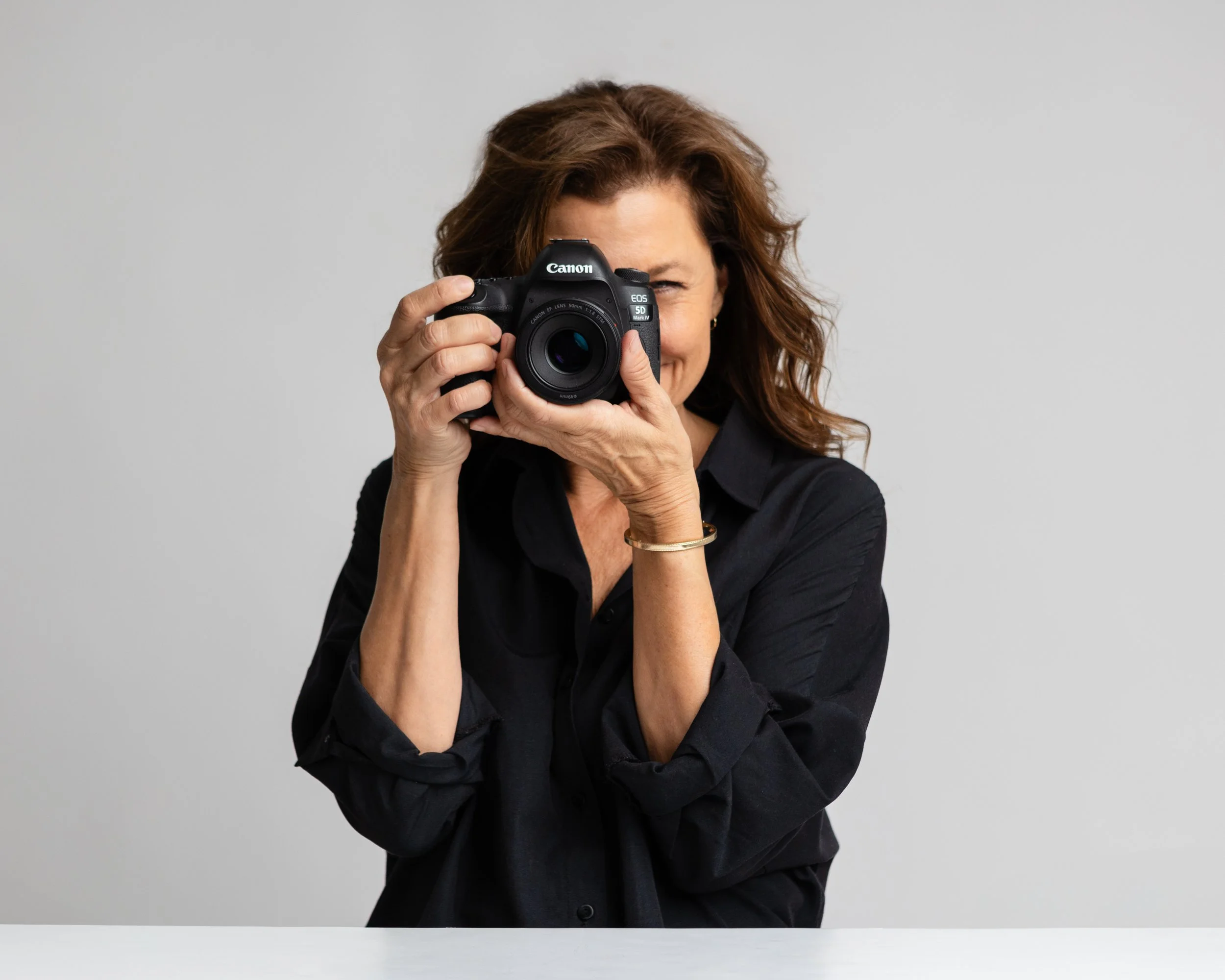 Los Angeles portrait and fine art photographer Christine Harris holding her Canon camera, photographed for her website by Christine Harris Photography.