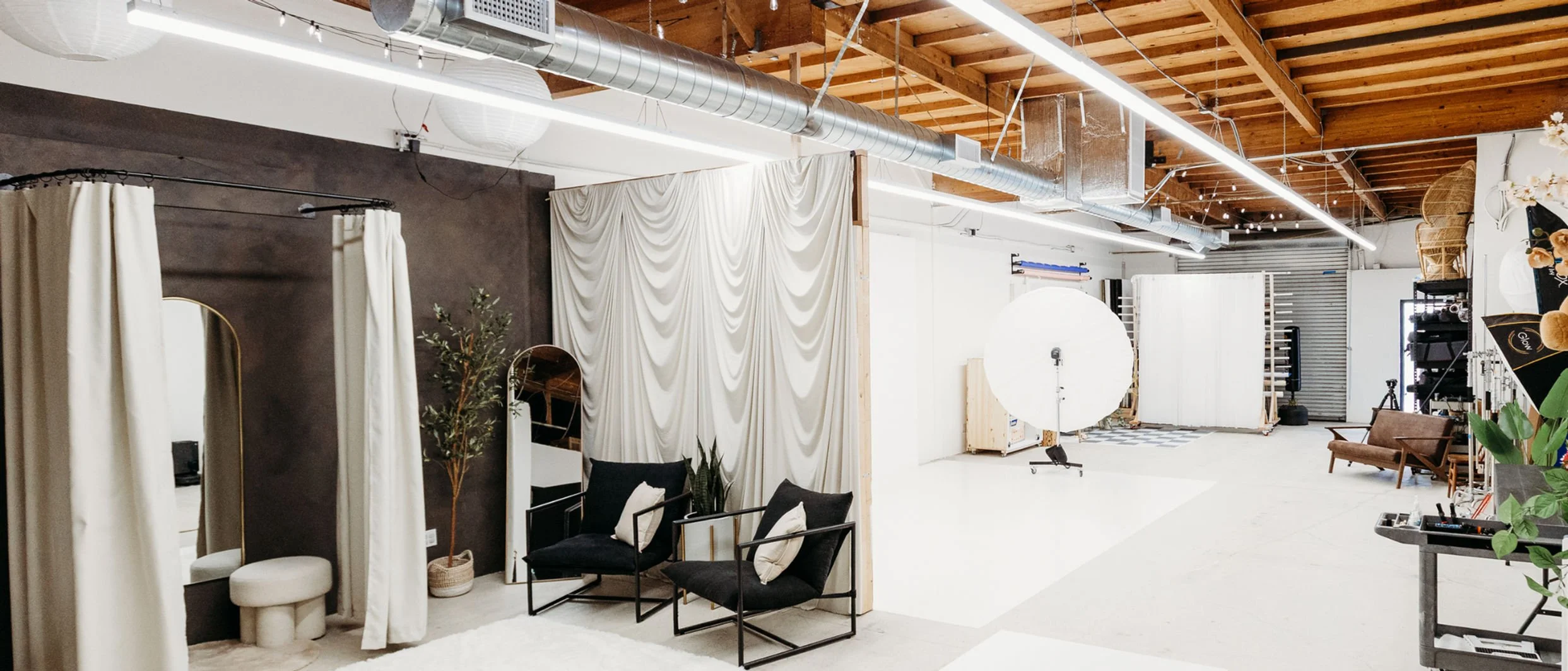 Warehouse space inside The Arlen Studio in Westlake Village, California, featuring multiple shooting scenes, draped backdrops, and production-ready infrastructure. Photography by Christine Harris.