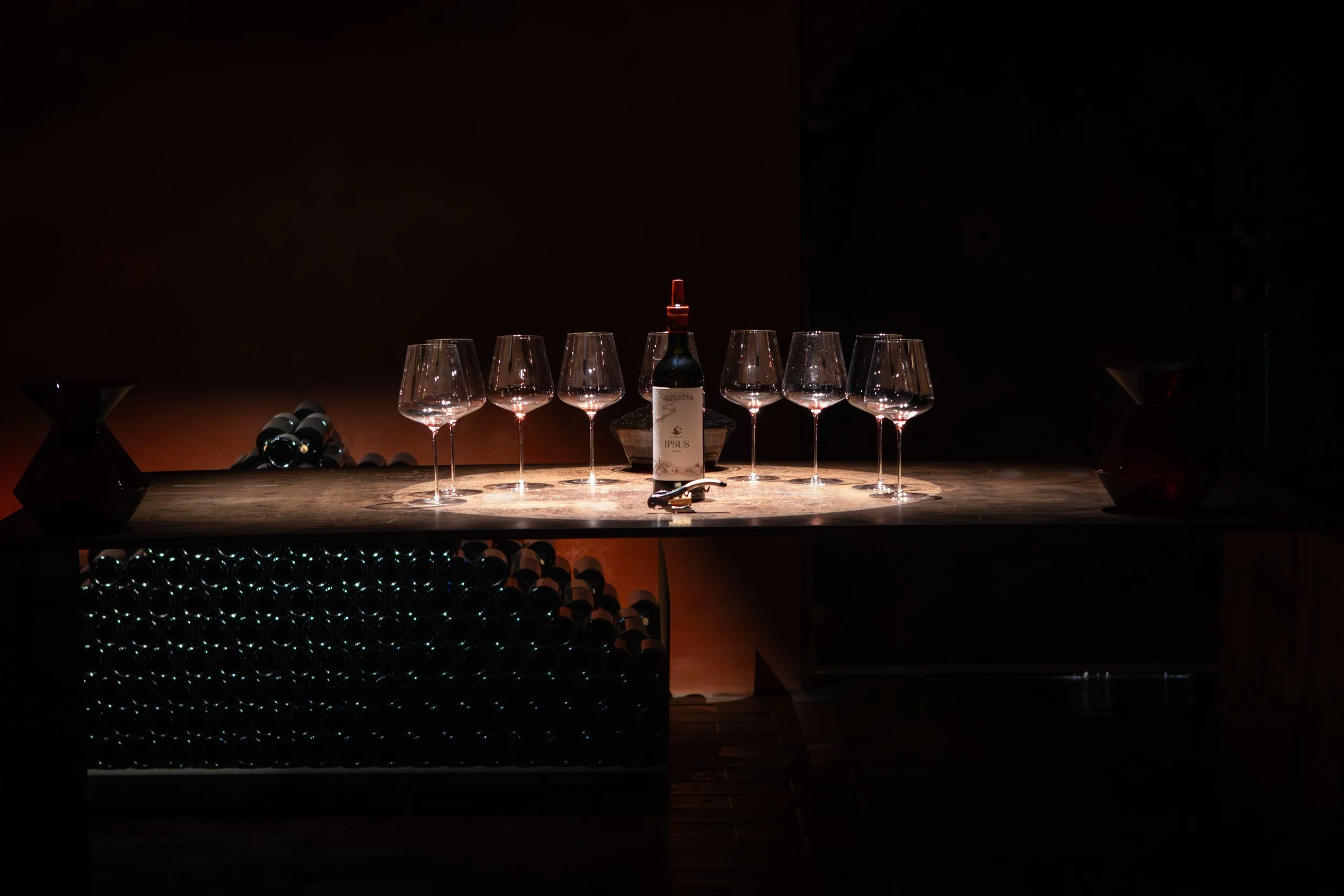 Wine glasses and bottle set for tasting at Ipsus winery, Tuscany. Photography by Christine Harris.