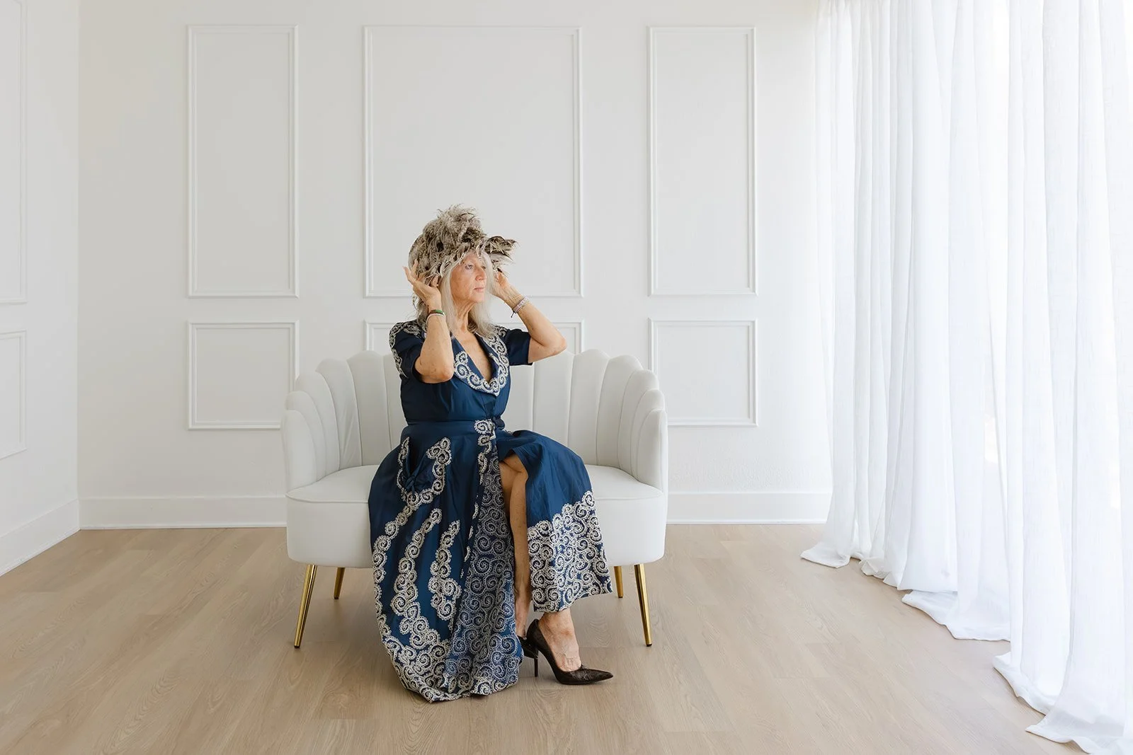 Leigh Kilton-Smith seated in a white chair during her 50 Women Project portrait session.