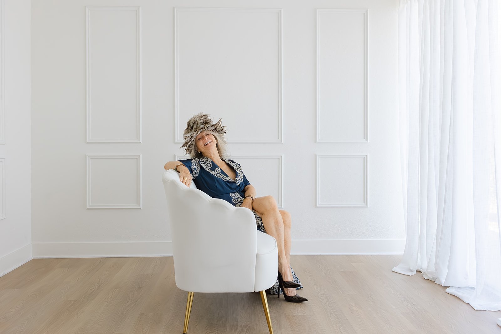 Leigh Kilton-Smith relaxing in a chair during her 50 Women Project portrait session.