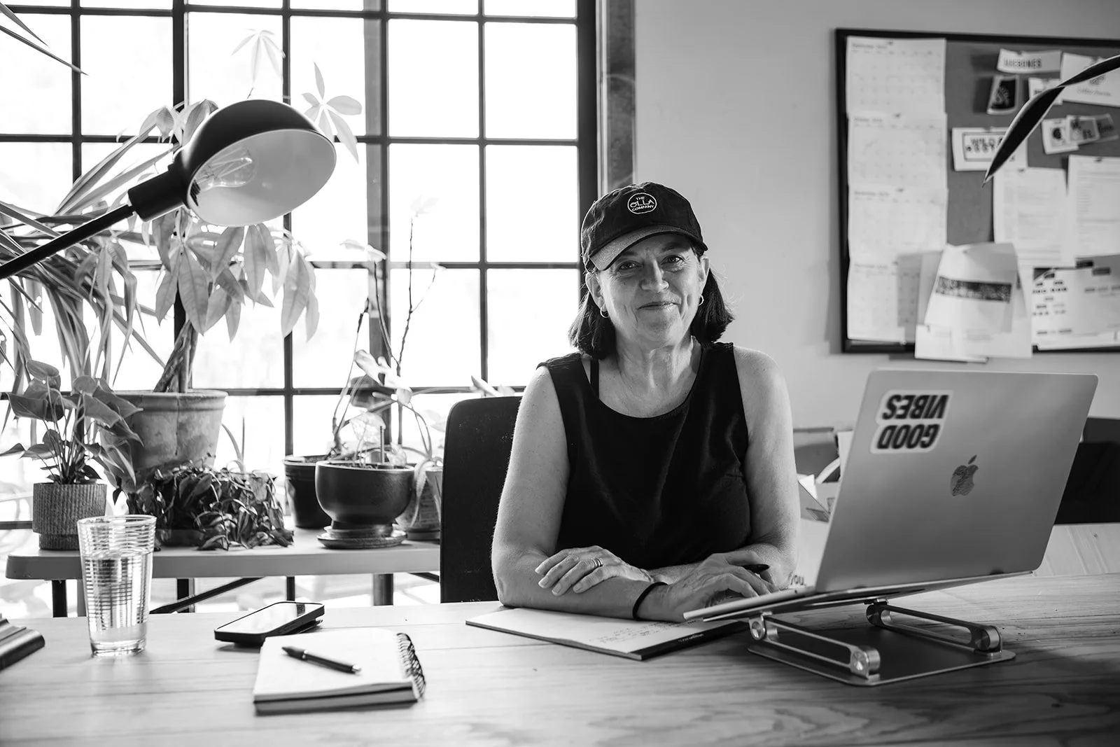 Paula Hodgson, founder of The Olla Company, working at her home office desk, photographed by Christine Harris