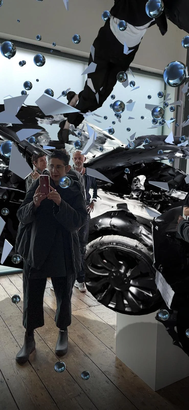 Art exhibit with digital effects, featuring people viewing an installation with reflective spheres and shattered pieces, in a gallery setting.