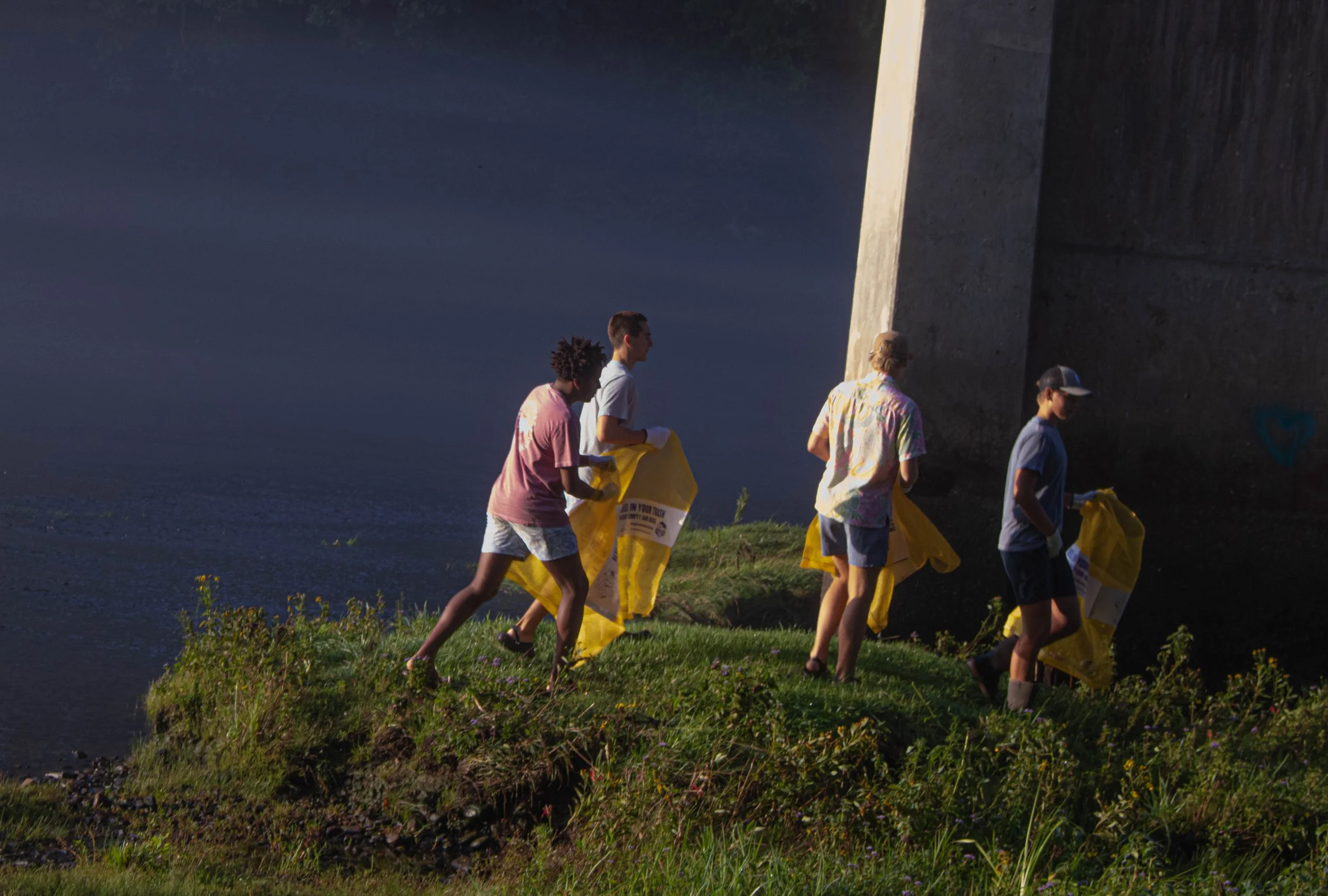 a group of volunteers collecting trash along the Little Red River