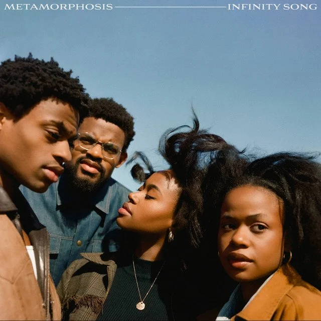 Four people standing outdoors against a clear blue sky, with the album titles 'Metamorphosis' and 'Infinity Song' written at the top. Album artwork for "Metamorphosis" by the band Infinity Song.