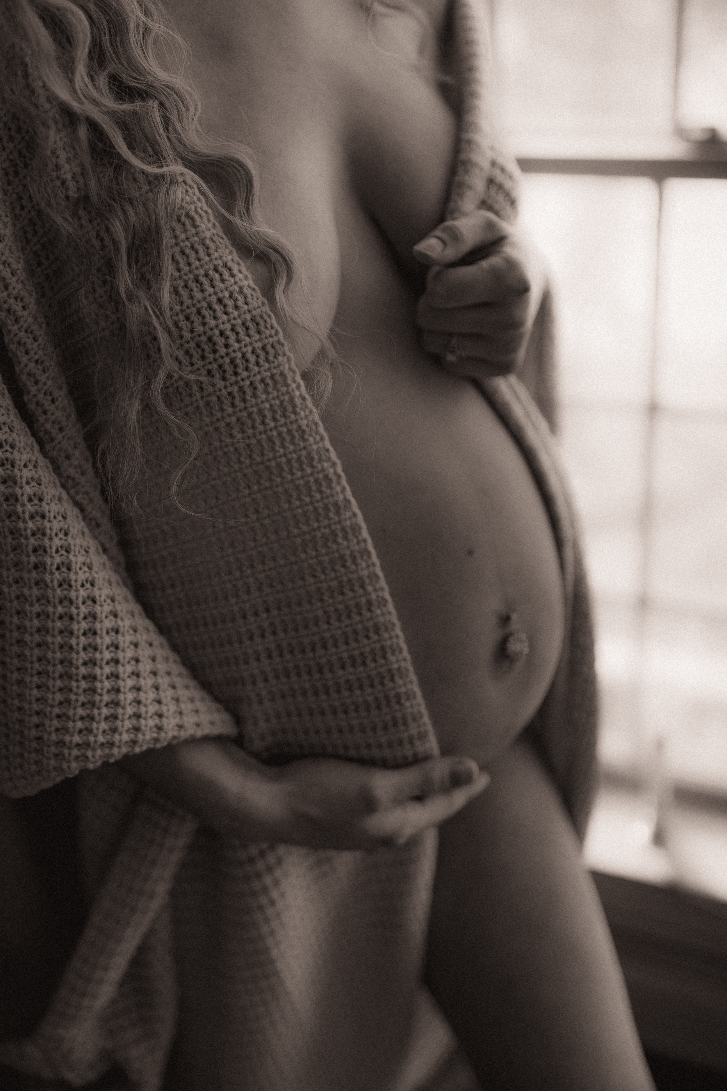 Maternity photos of woman holding belly in a beautiful historic Vermont home