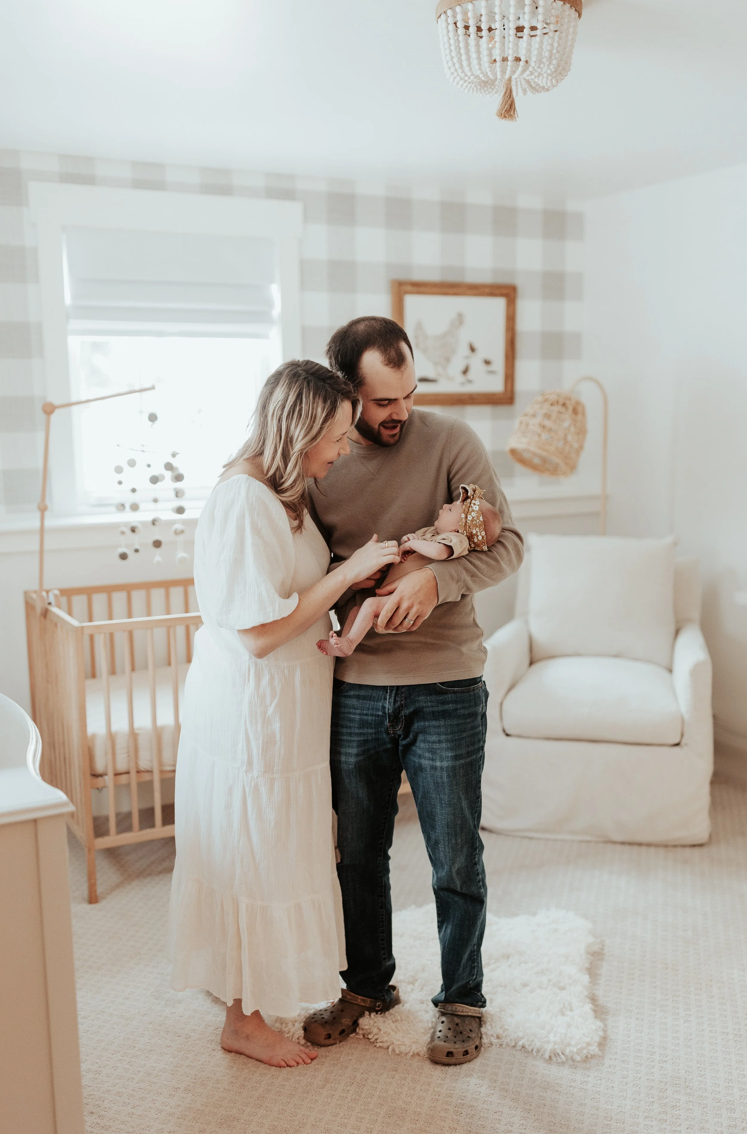 Vermont family snuggling newborn baby in in-home newborn session