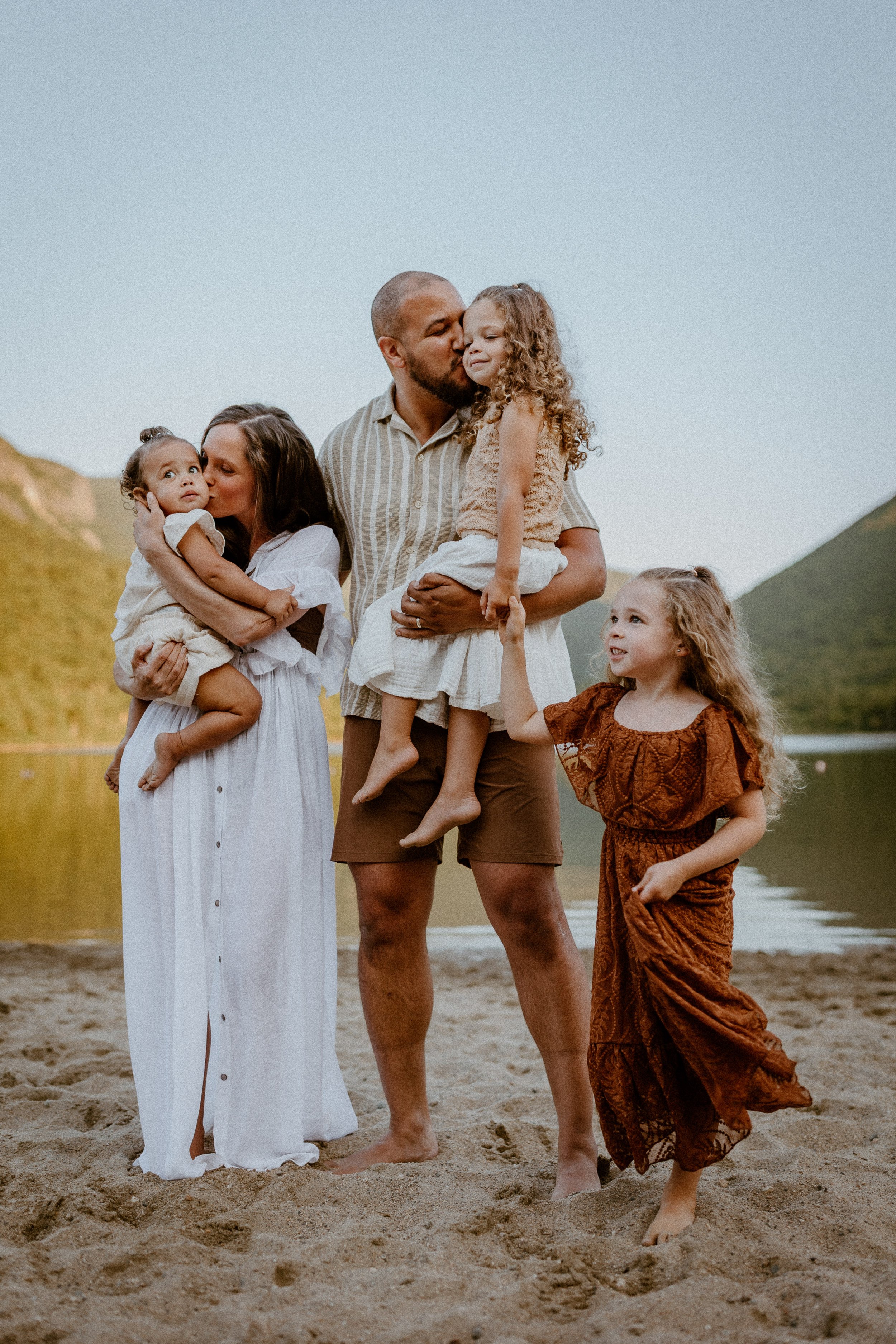 Vermont Family near lake snuggling and kissing