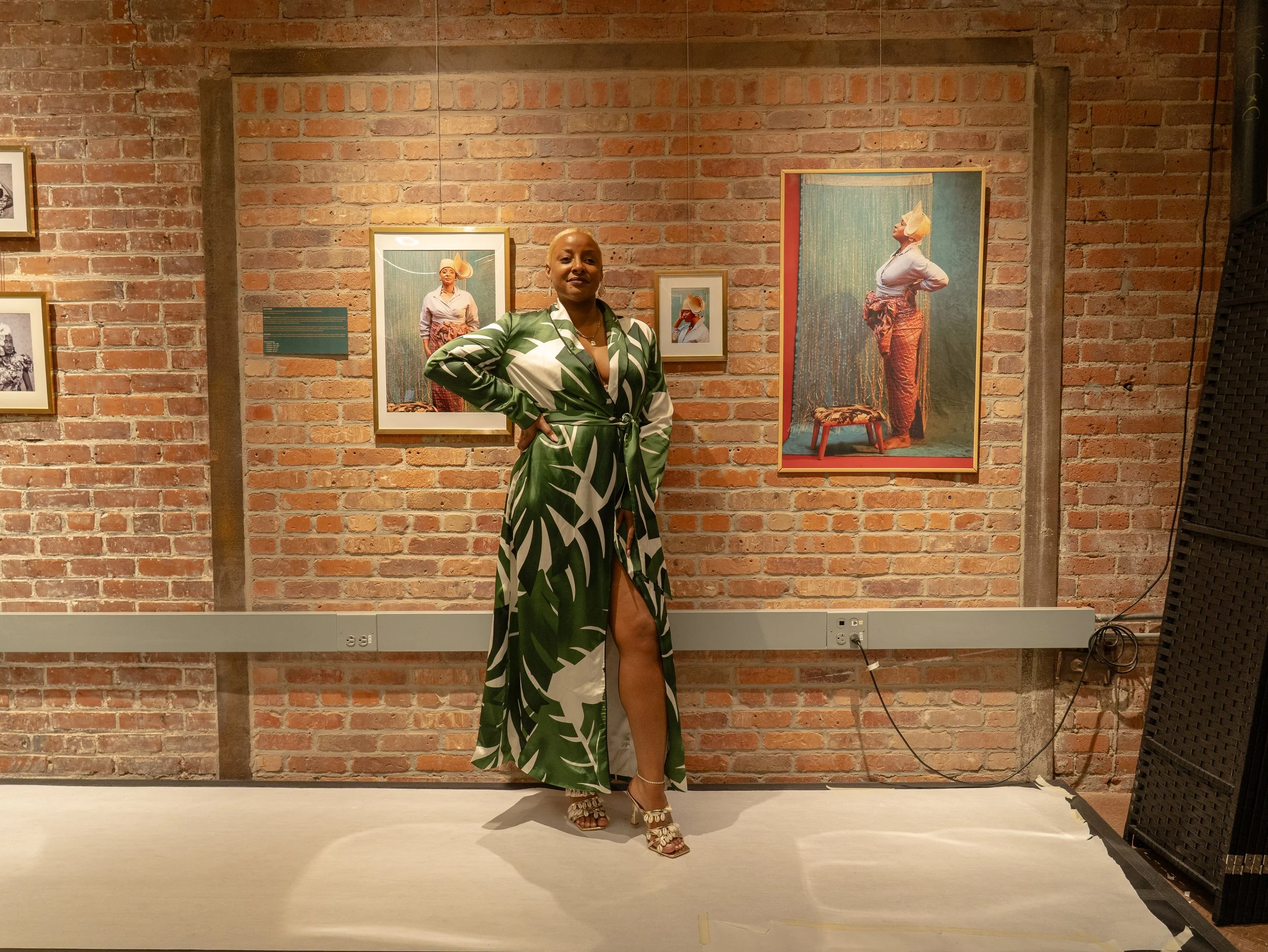 Steffie poses in front of her portraits at the CEI