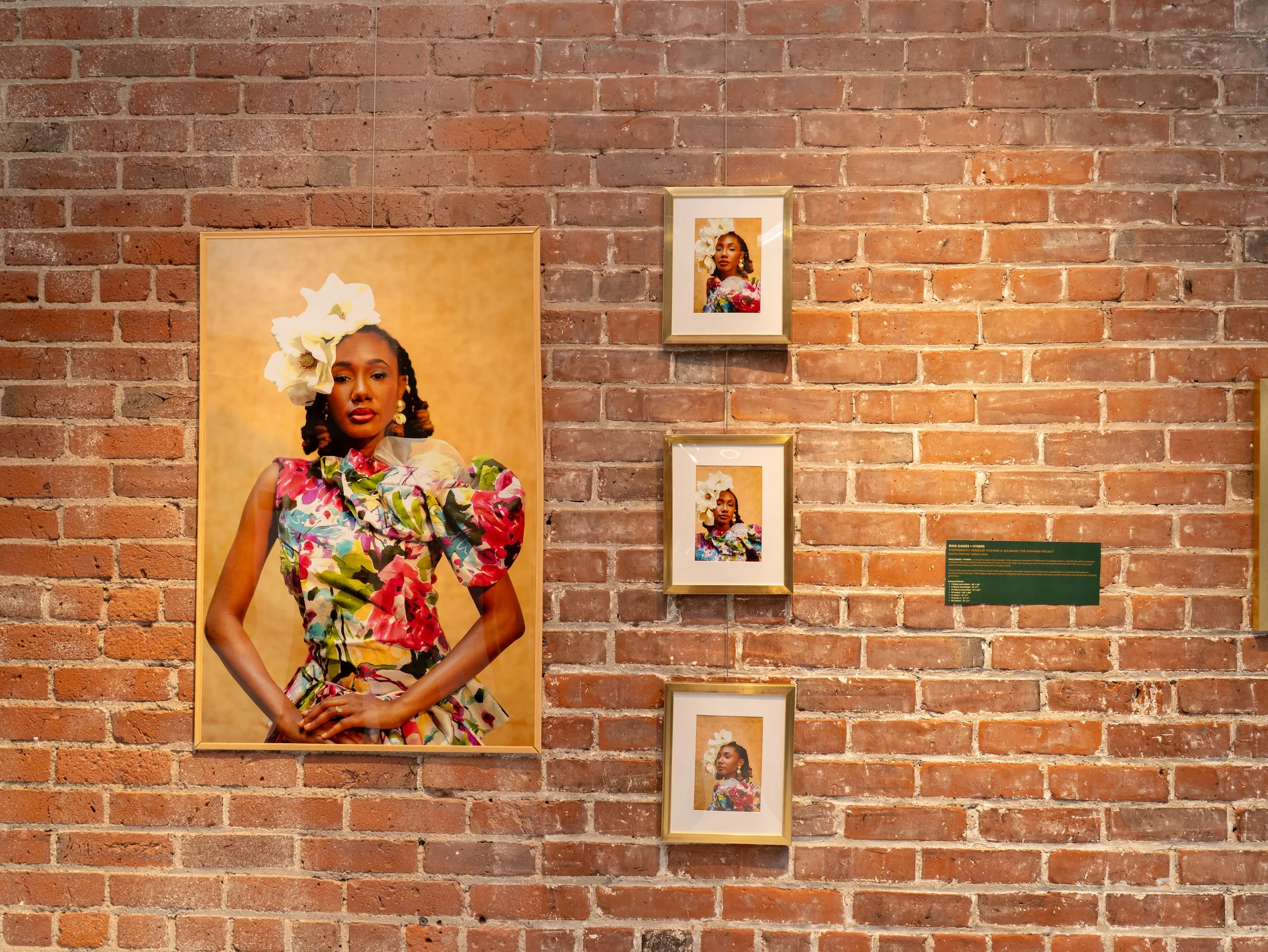 Portraits by Steffie Belnavis are displayed on the brick walls of the CEI