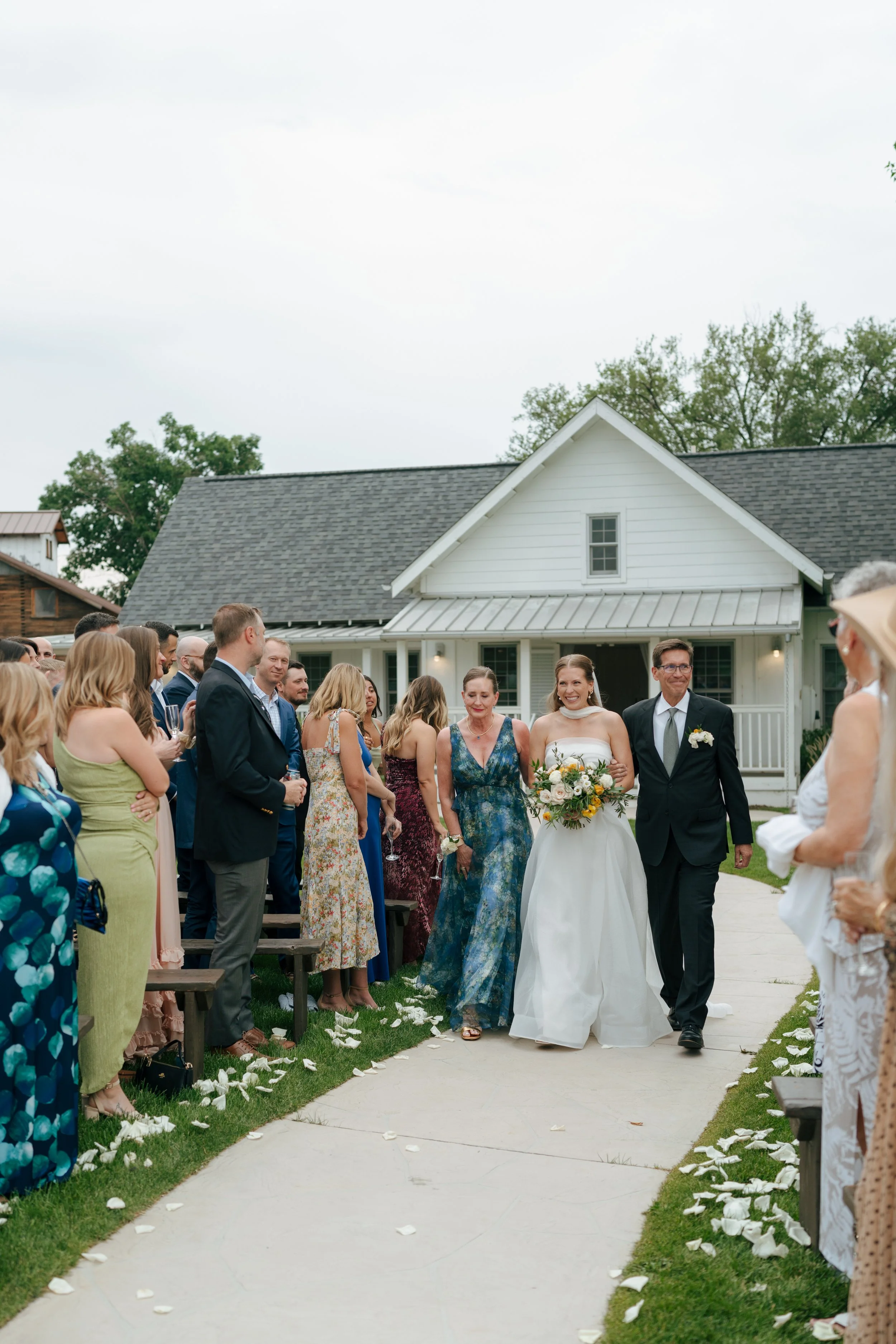 bride walking down the aisle with her parents at The Barn at Raccoon Creek