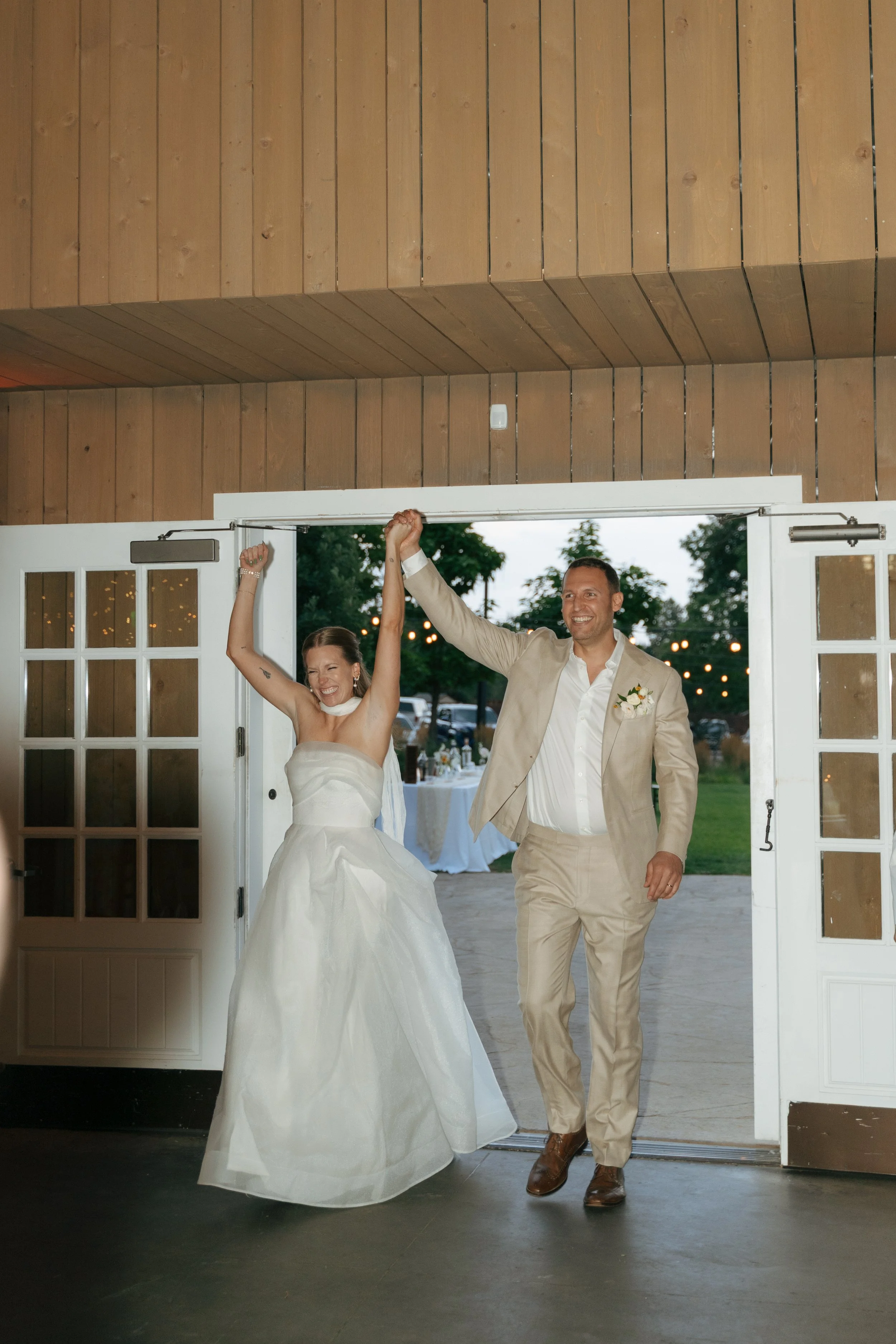 bride and groom entering the reception