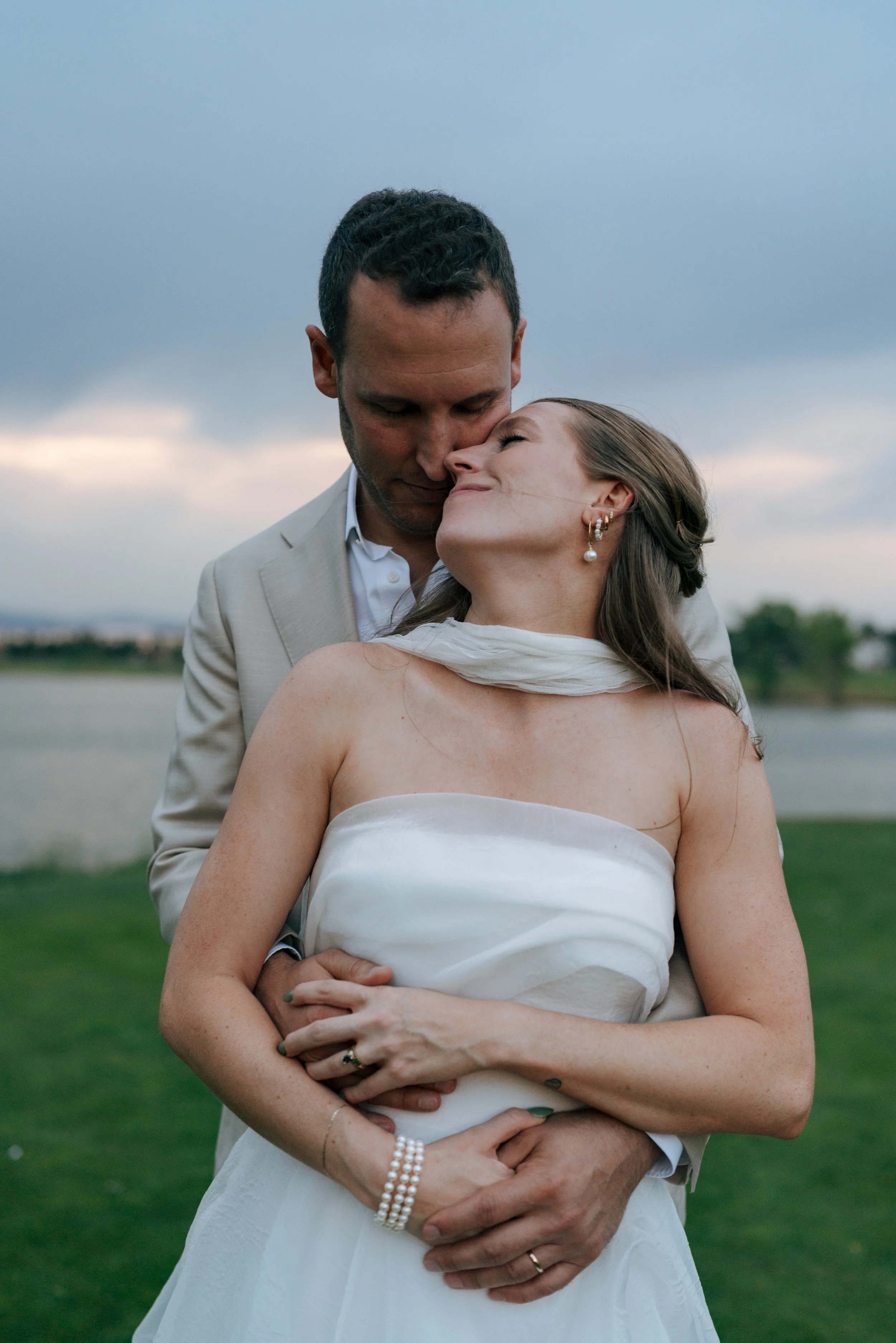 groom hugging bride from behind