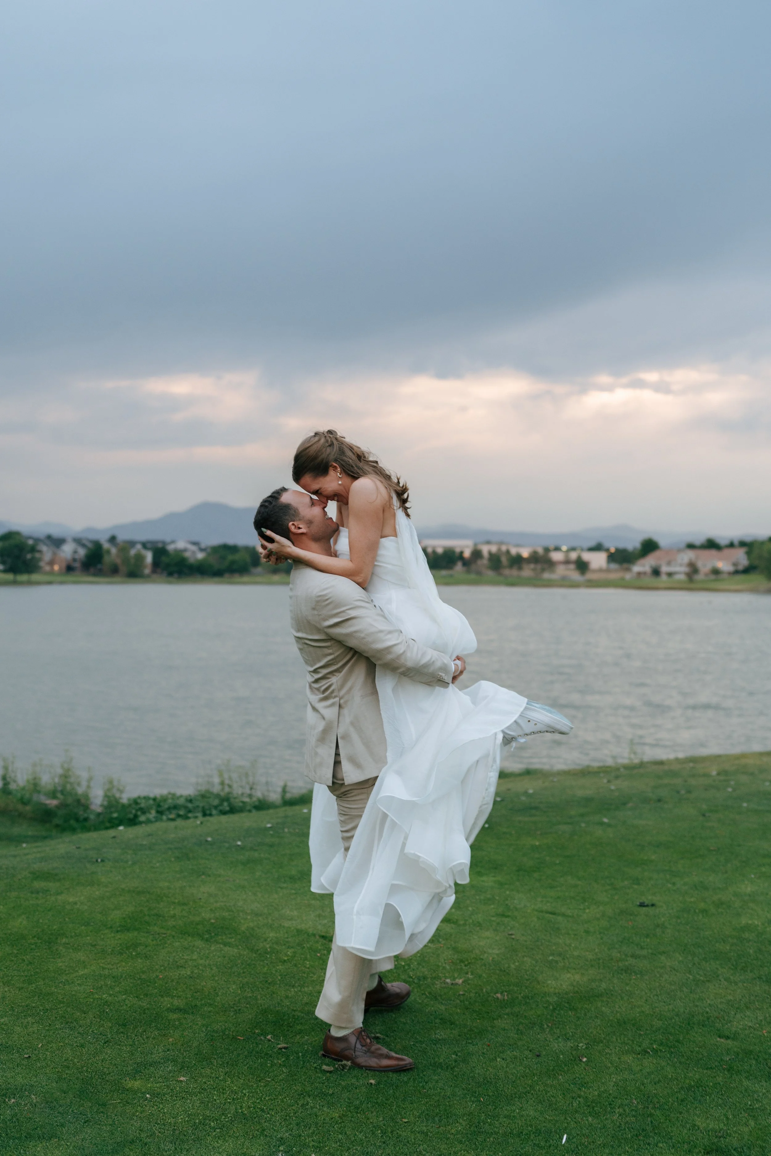 groom picking up the bride as they kiss
