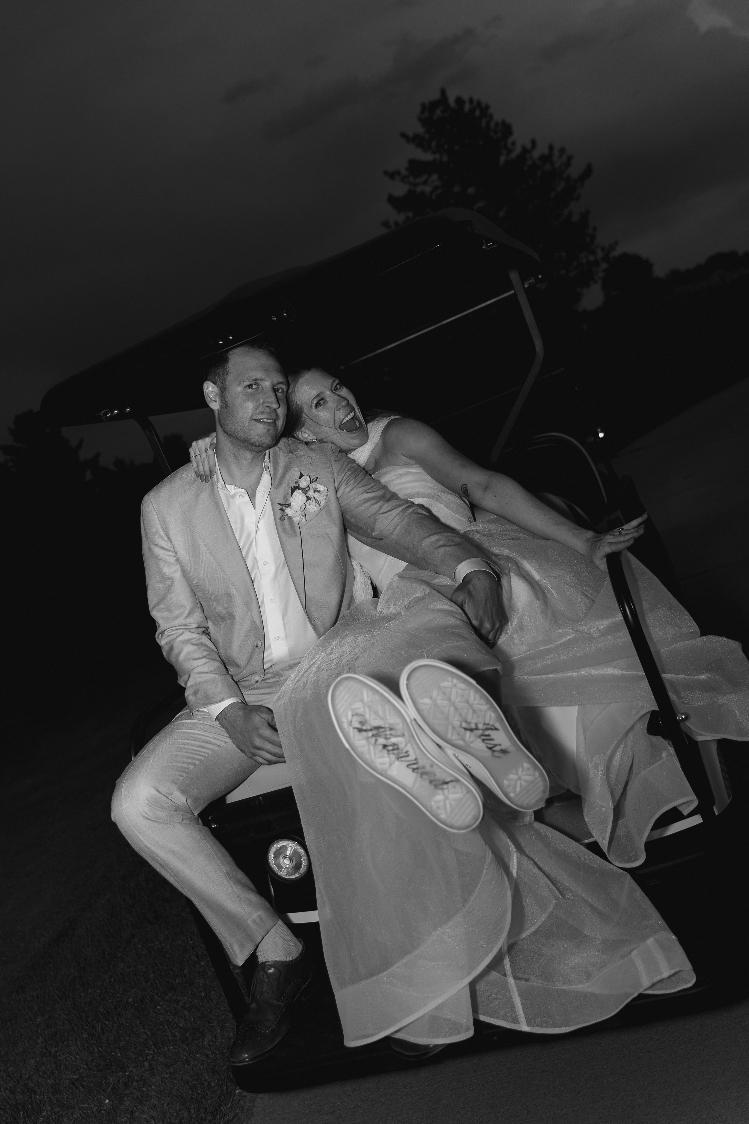 bride and groom on a golf cart at The Barn at Raccoon Creek