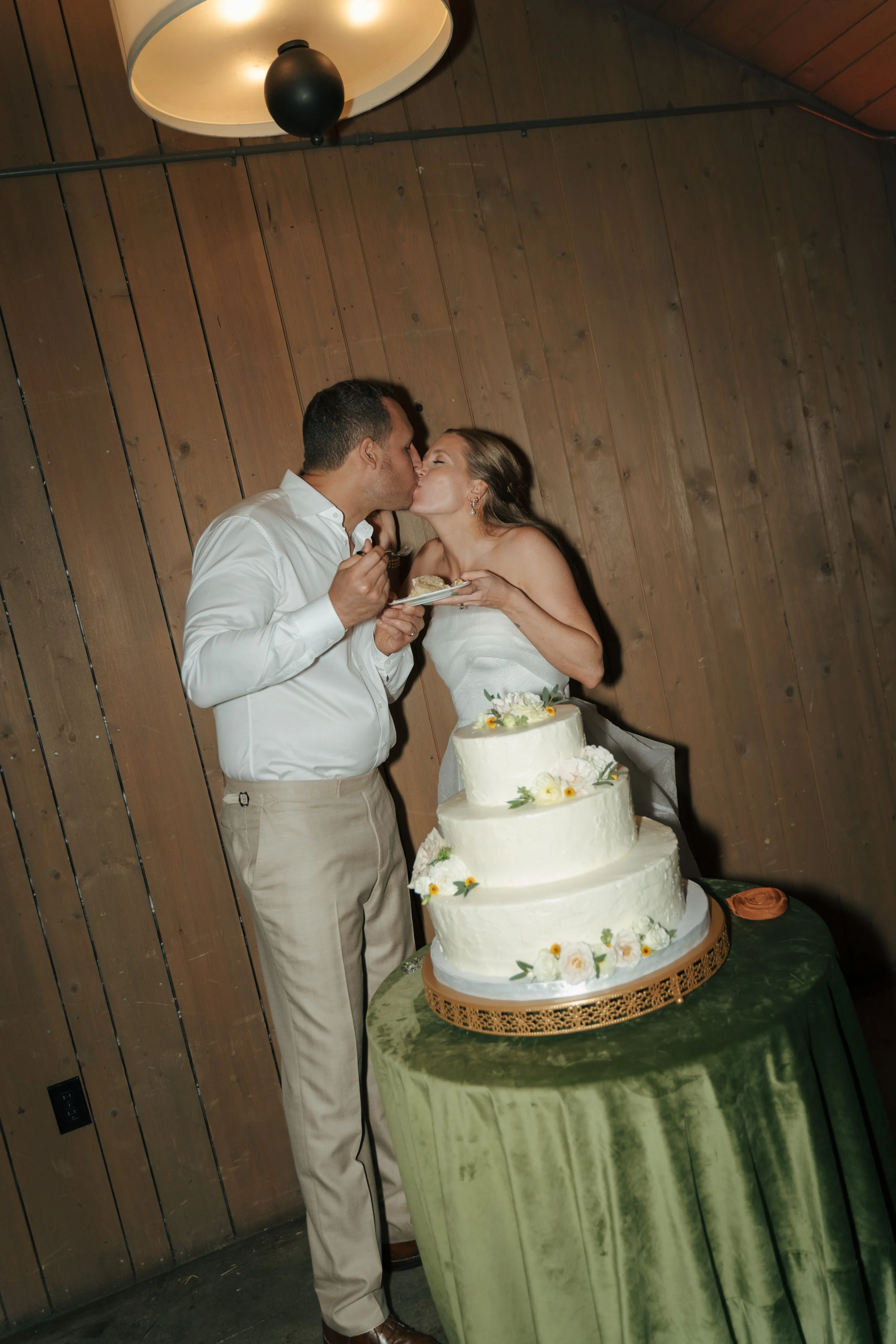 bride ad groom eating cake at The Barn at Raccoon Creek