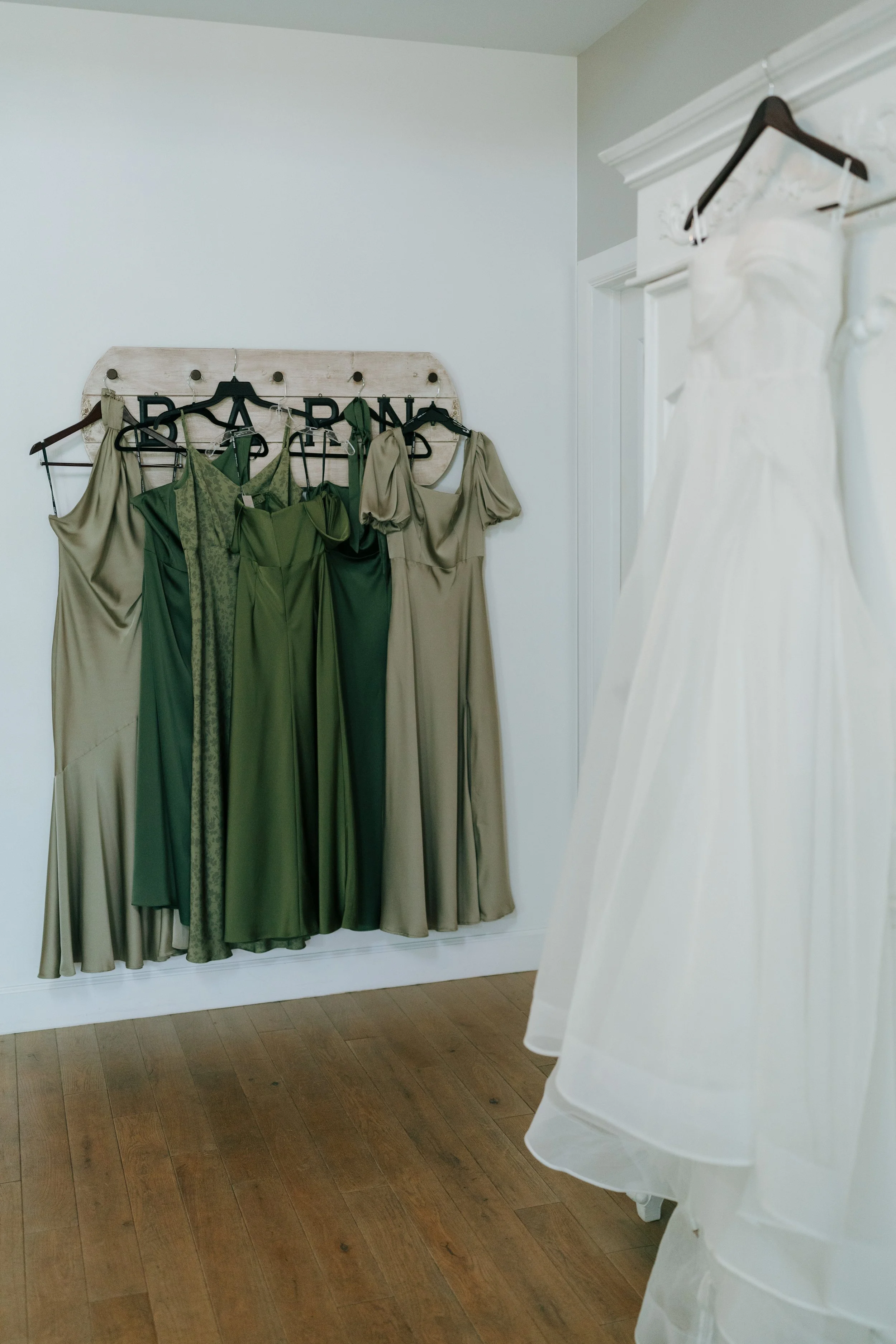 bride and bridesmaids dresses hanging up 