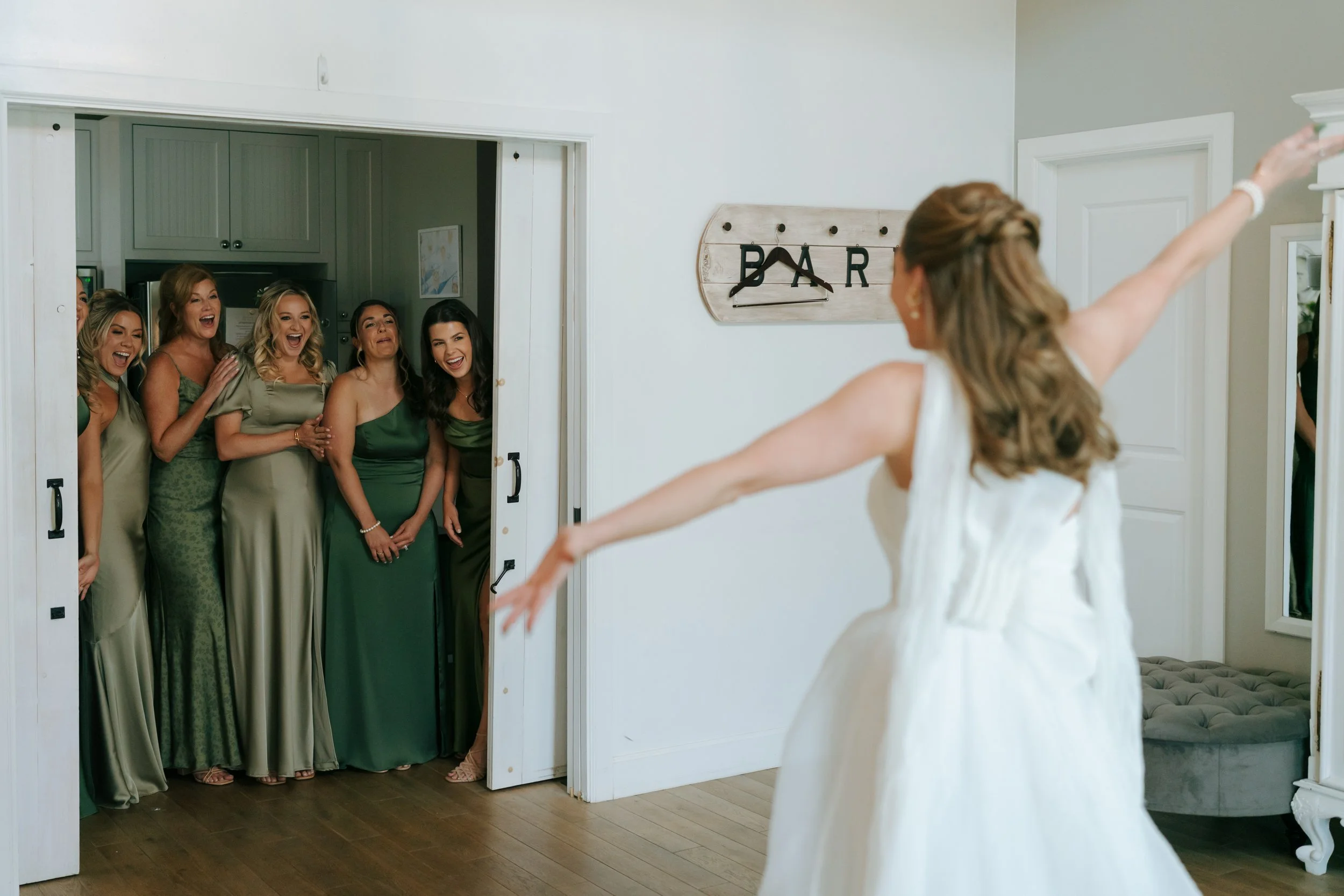 bride doing a first look with her bridesmaids