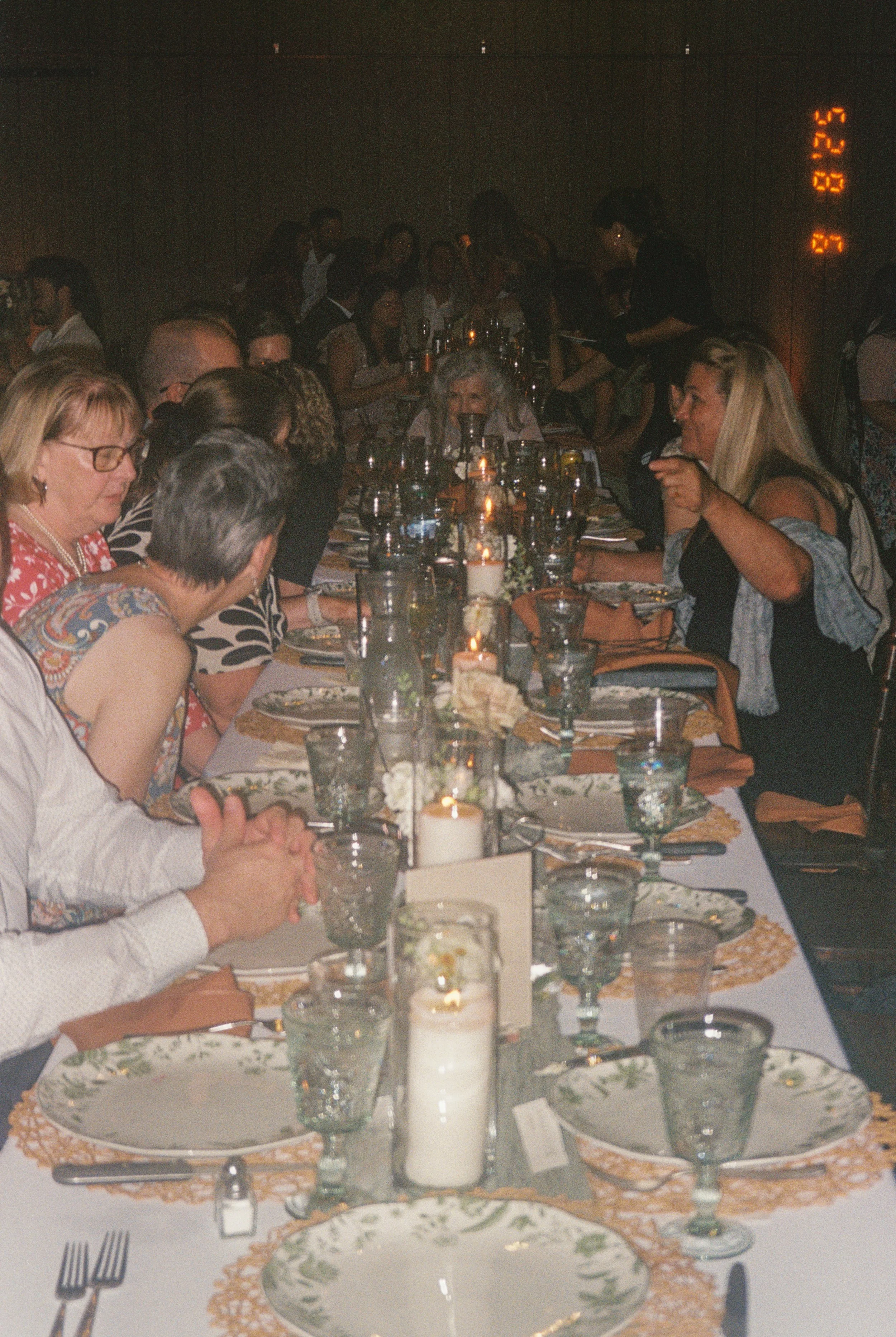 film photo of the guests sitting at the reception tables