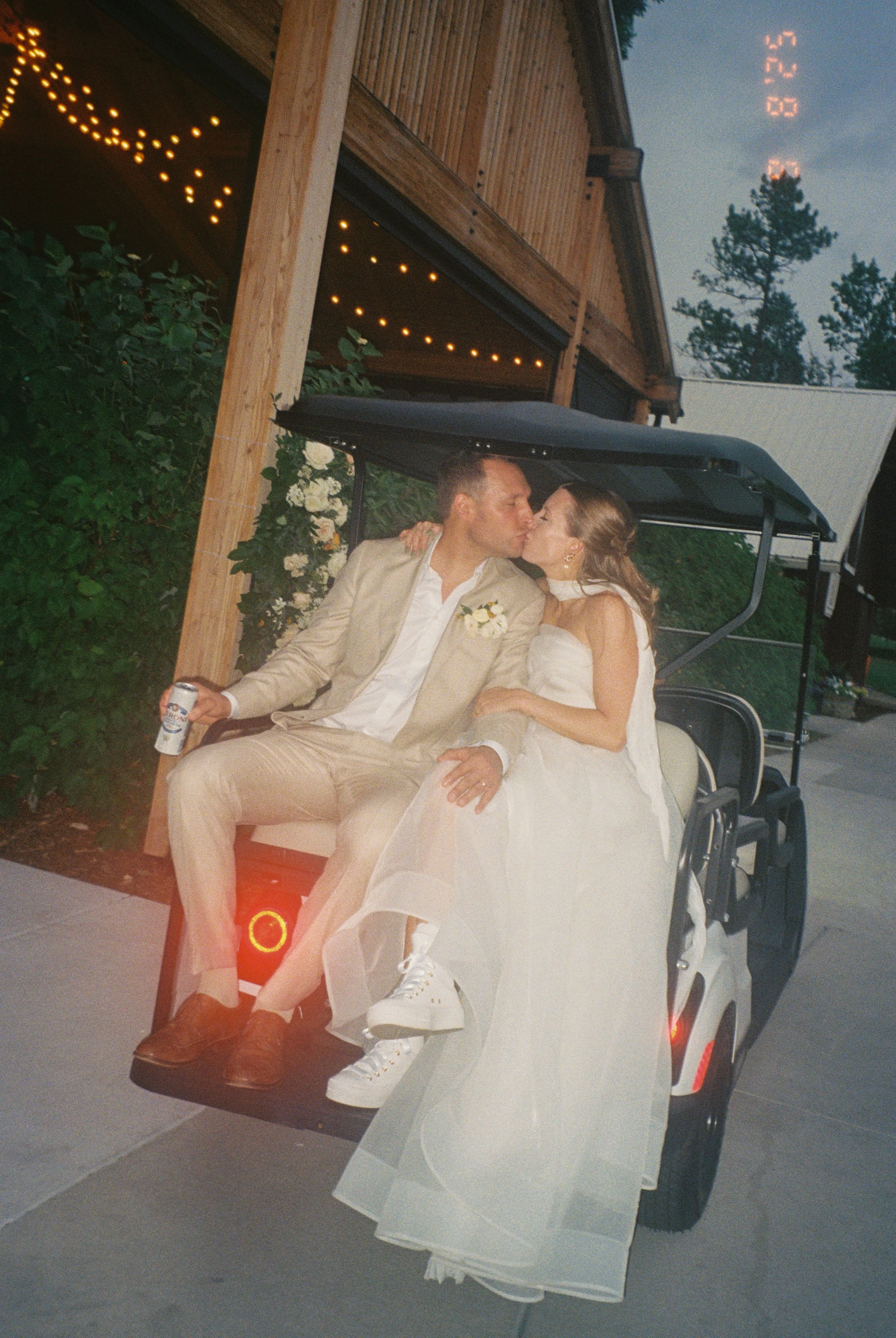 film photo of the bride and groom on a golf cart