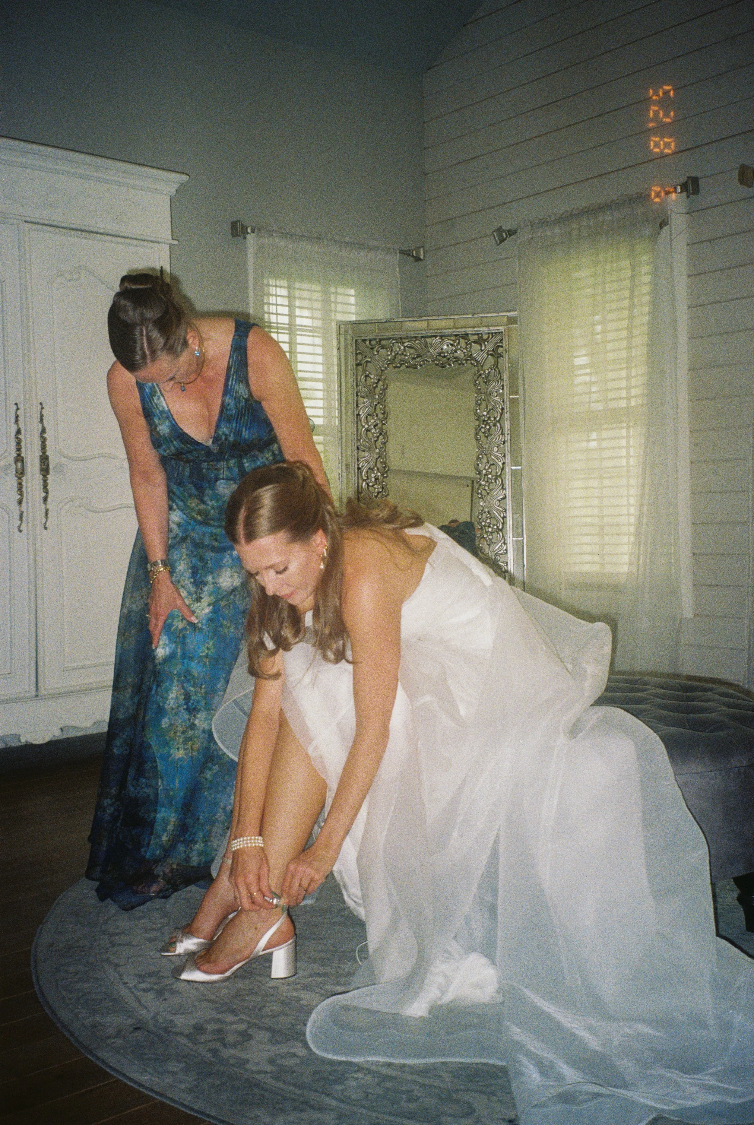 bride putting on her wedding shoes