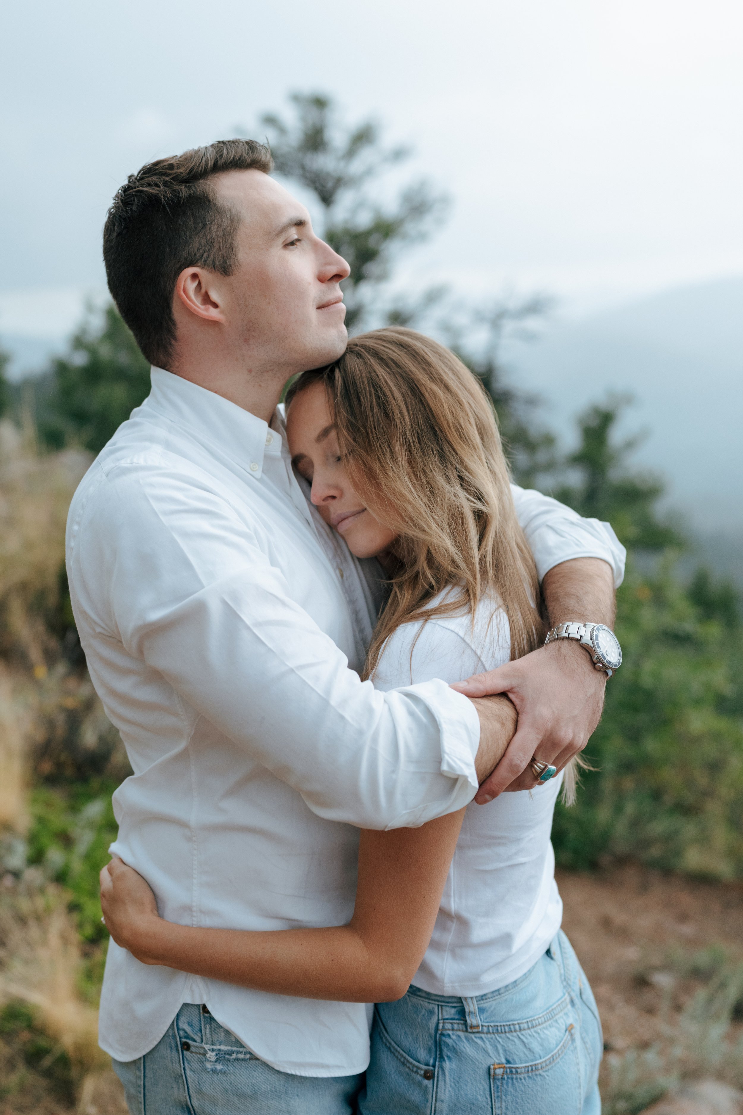 a couple hugging each other during their engagement photoshoot