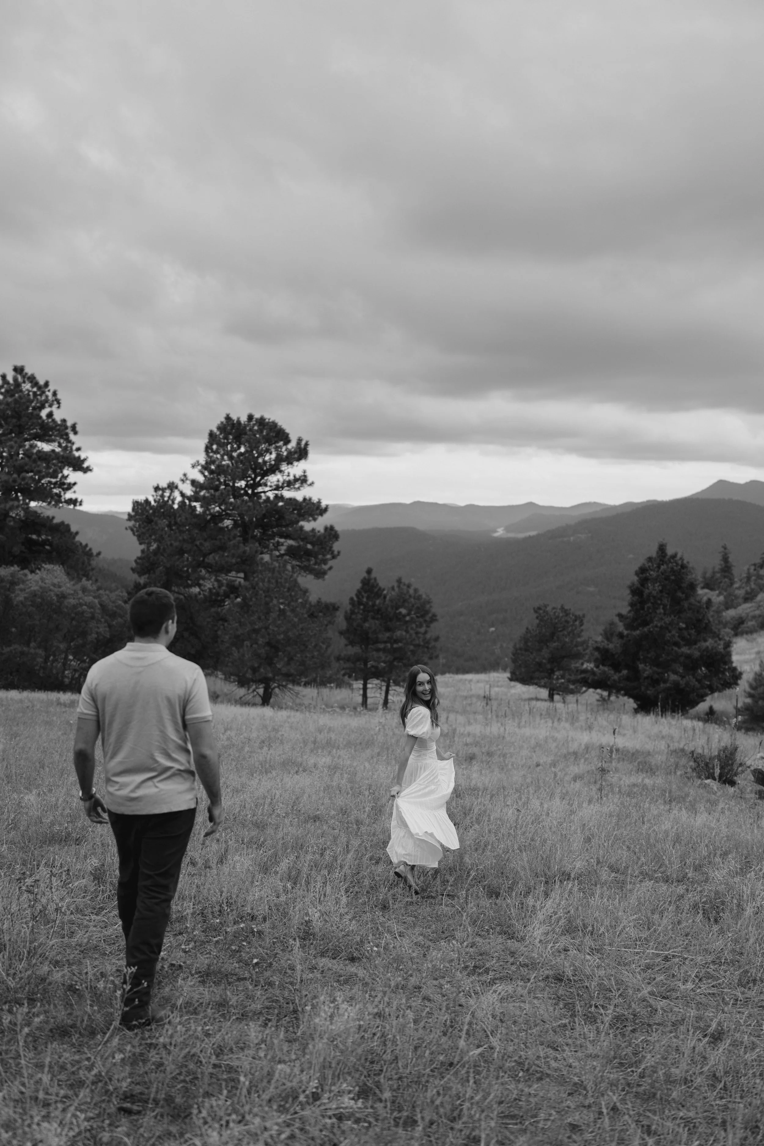 a couple walking through the grass in Colorado
