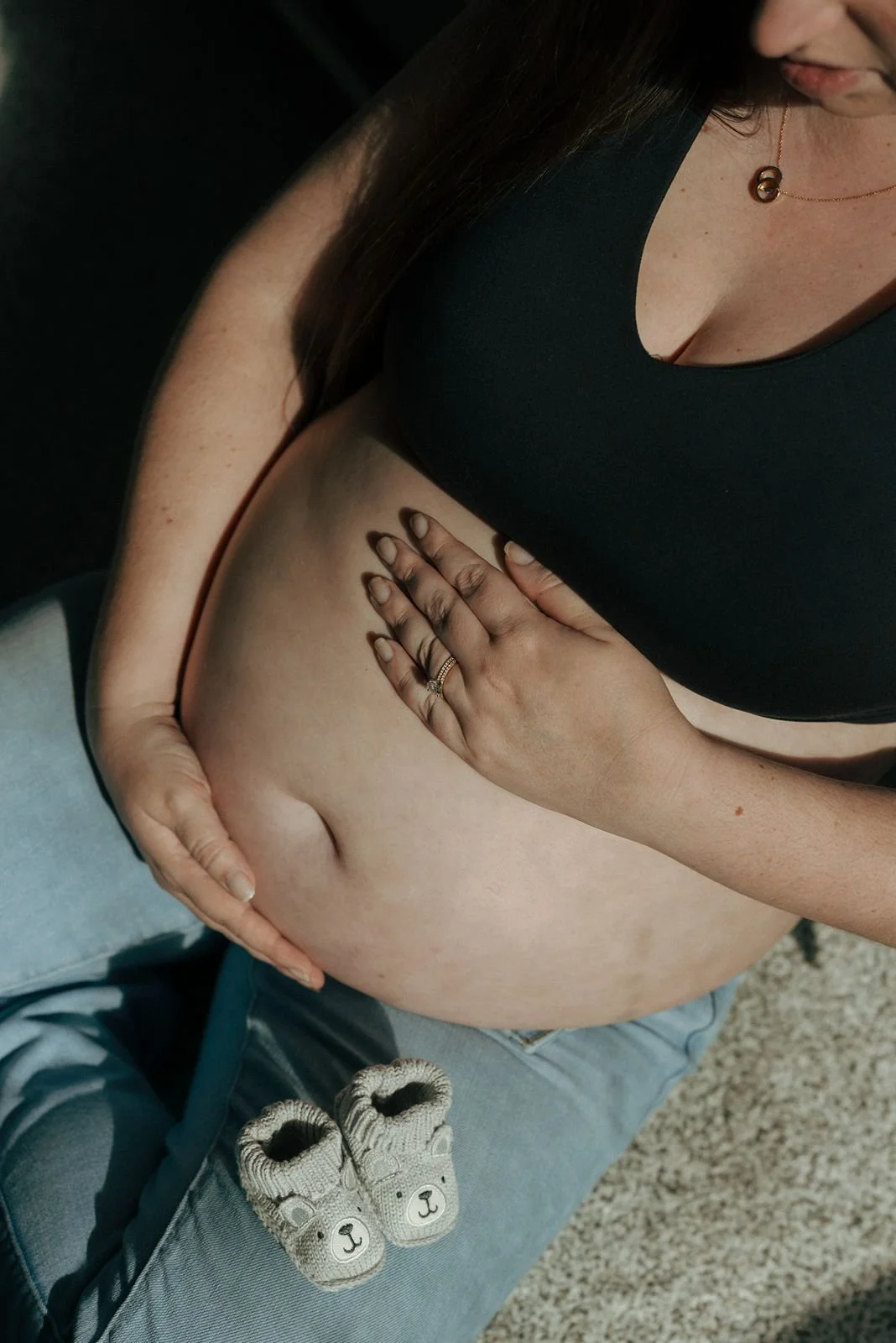 A pregnant woman holding her belly.
