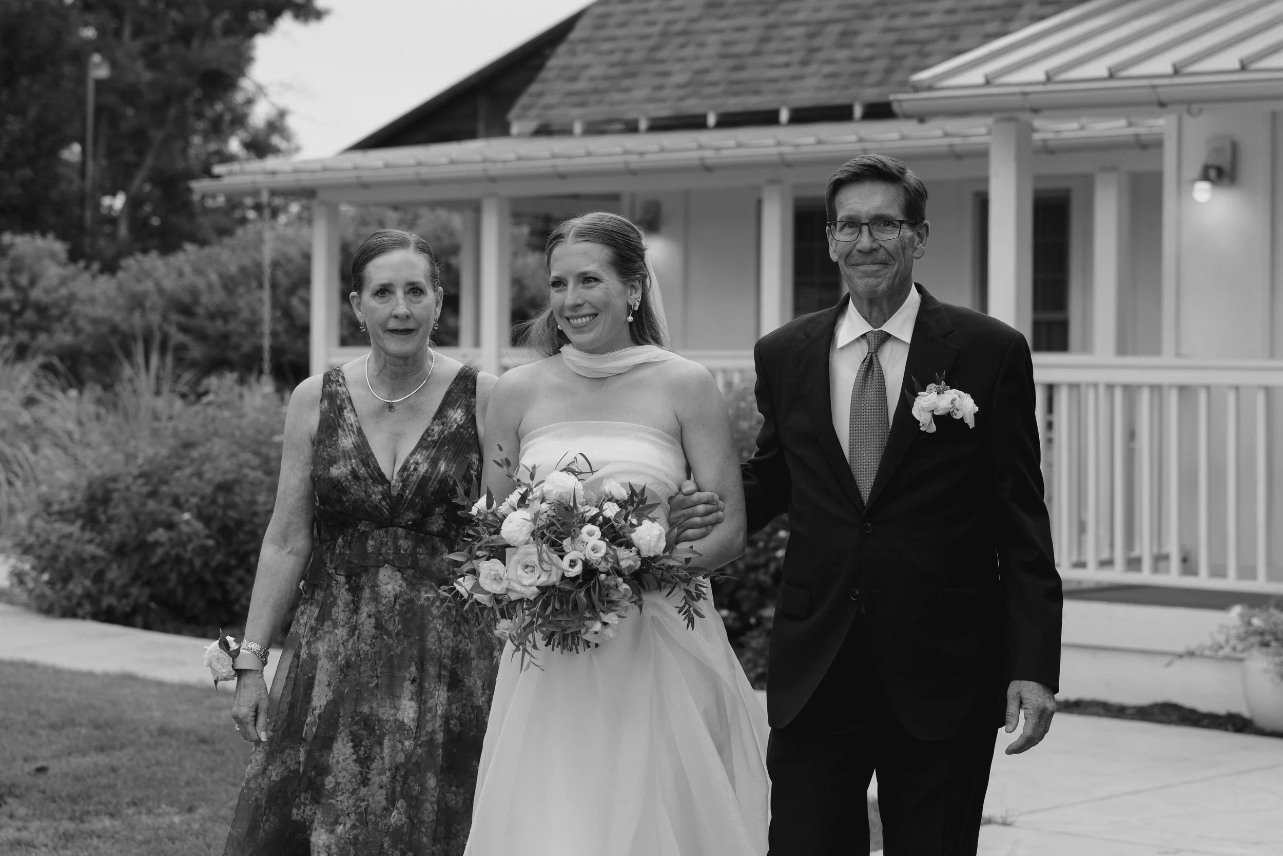 bride walking down the aisle with her parents at The Barn at Raccoon Creek