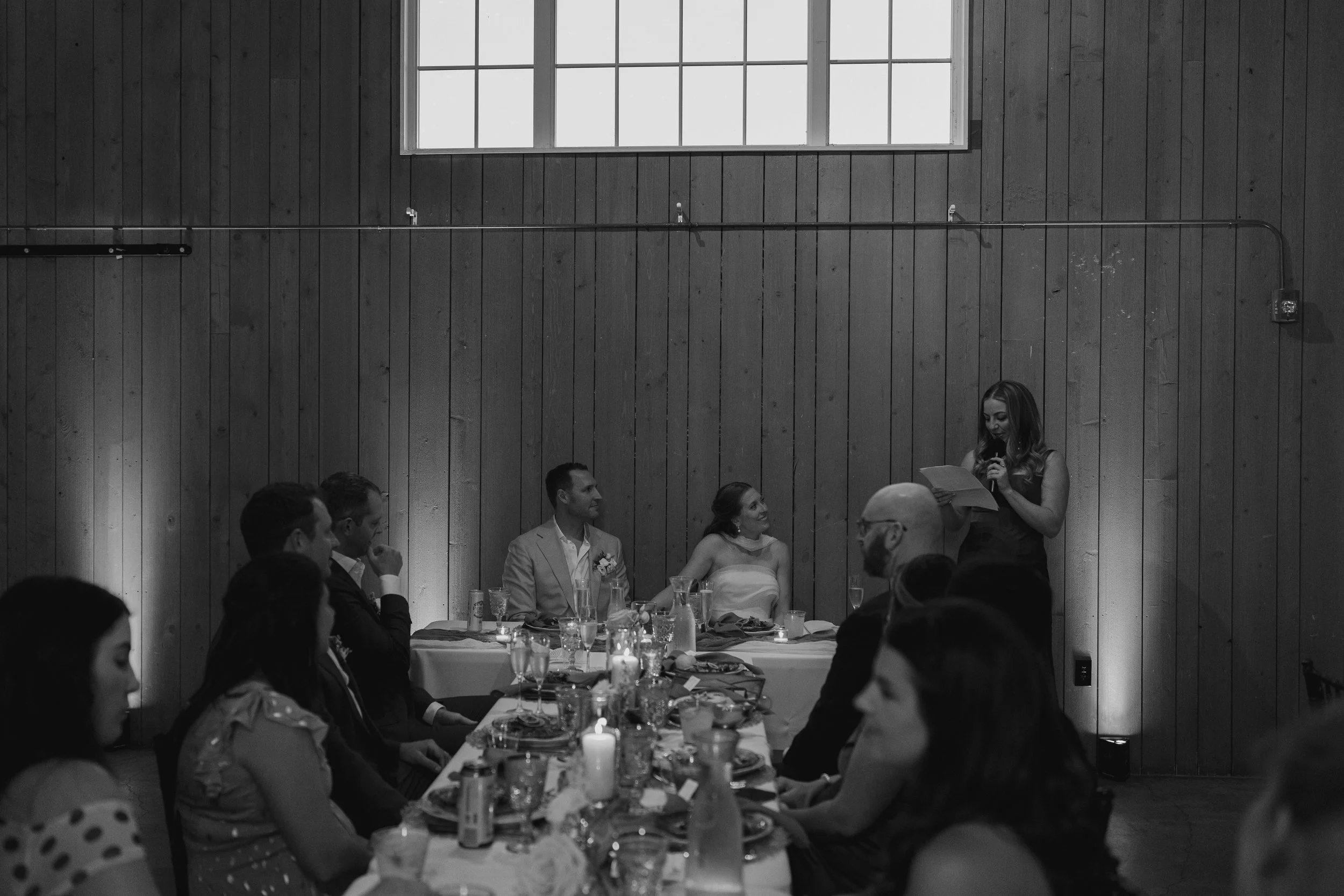 someone giving a speech during the reception at The Barn at Raccoon Creek