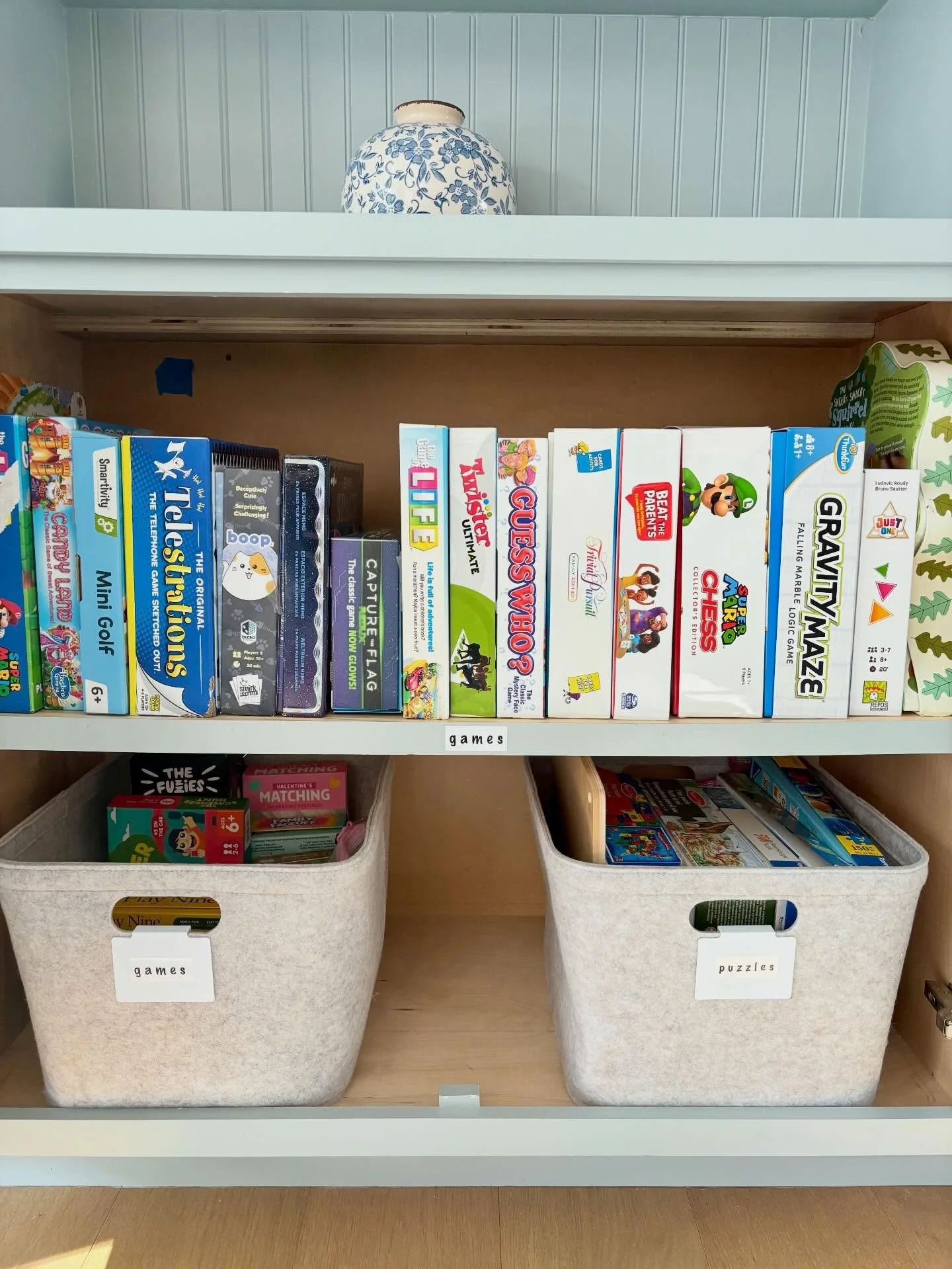 We get asked all the time how to store games &mdash; and this is one of our favorite solutions. 💫💫

✔️ Stack boxes like a library
✔️ Decant smaller pieces into pouches
✔️ Labels are always a must

Functional, neat, and easy for the whole family to 