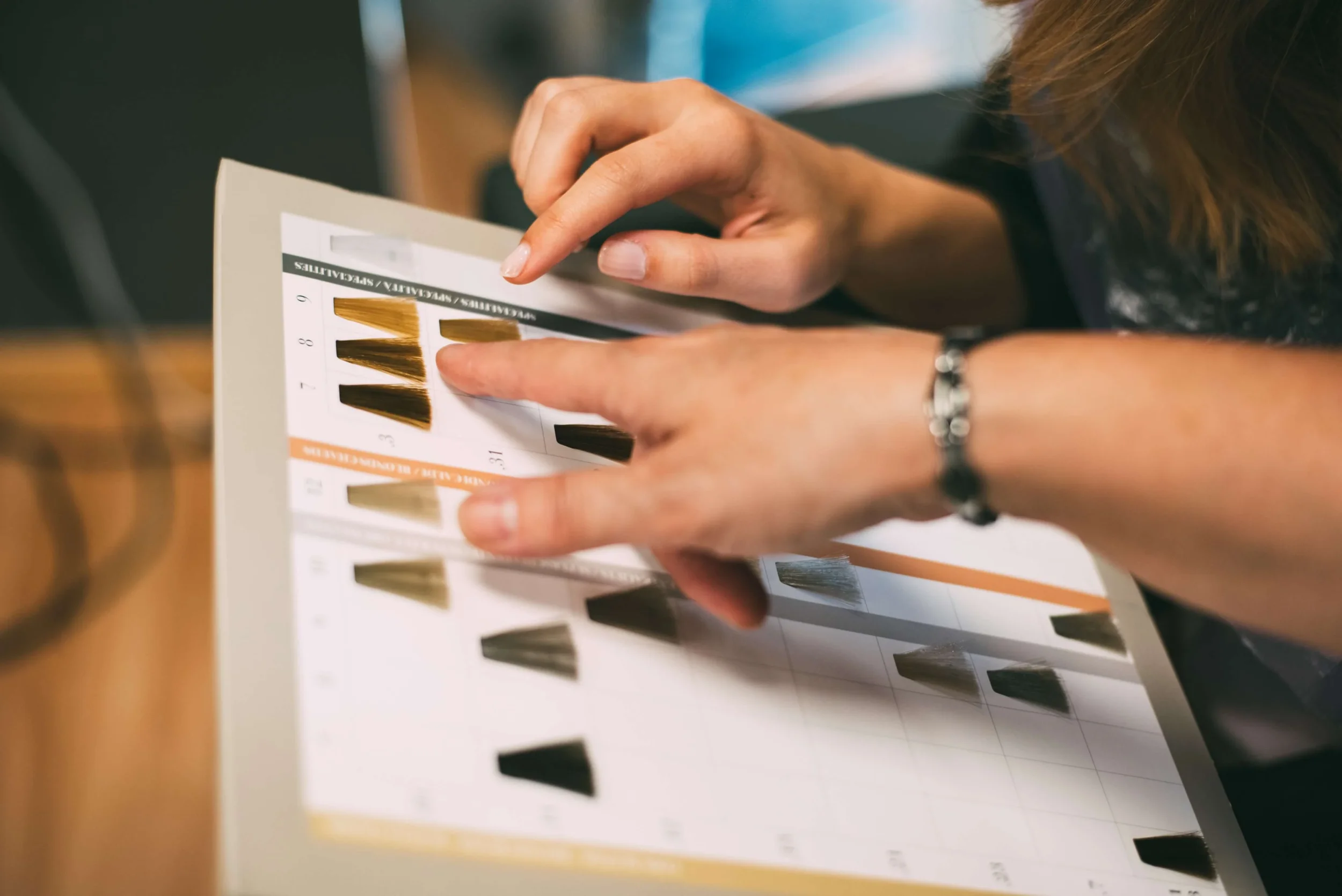 Women hands with a dye color catalog
