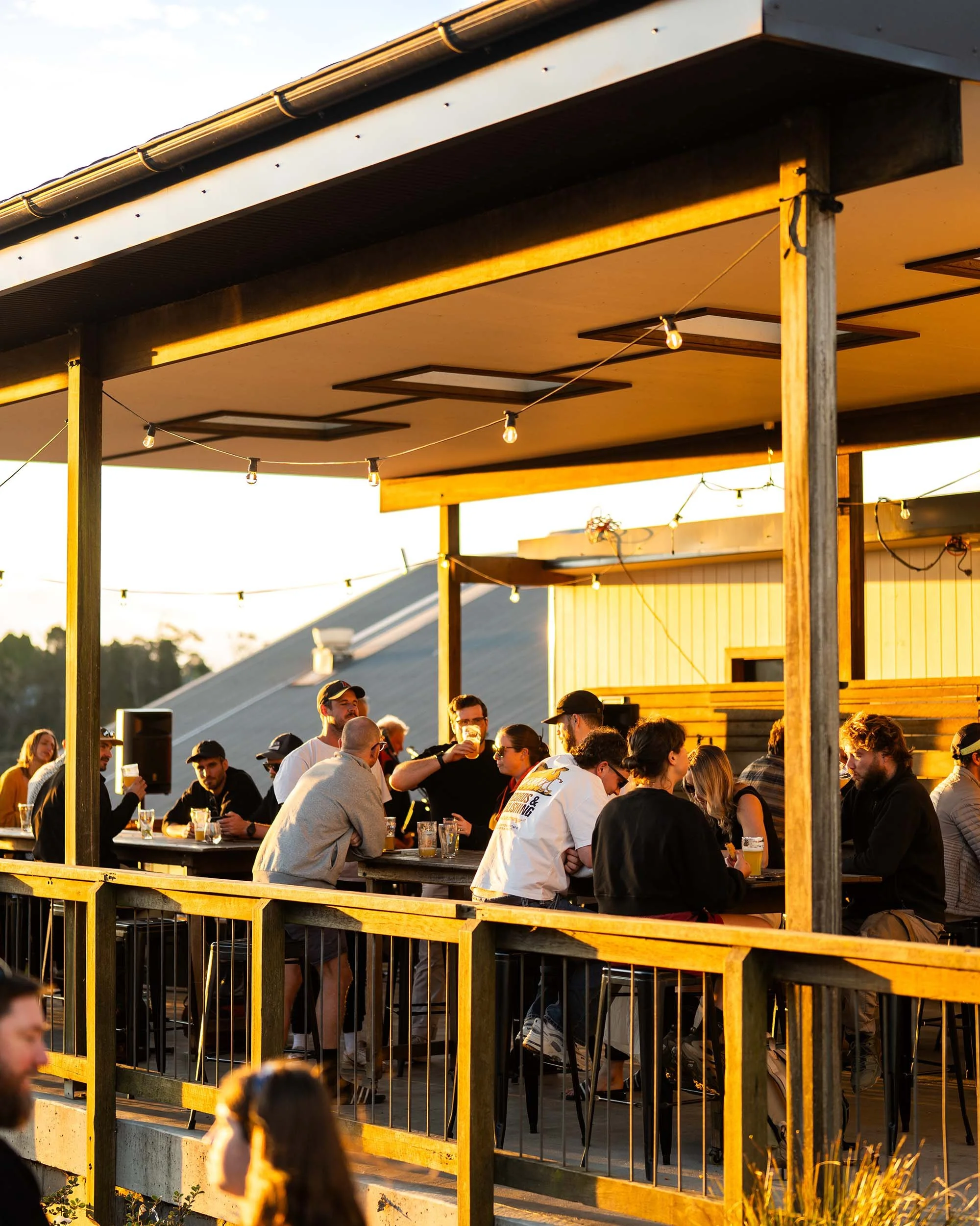 People enjoying drinks on an outdoor deck at Mountain Culture Beer Co in Katoomba