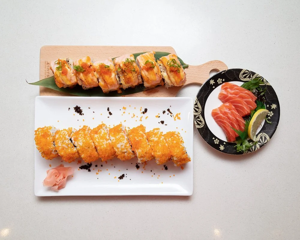 Fresh sushi rolls and sashimi platter with salmon and crunchy topping