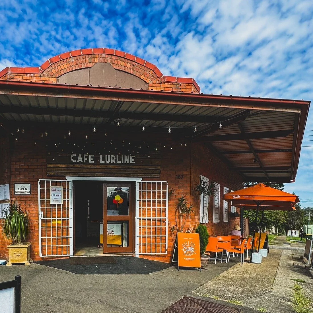 Exterior of Cafe Lurline in Katoomba with outdoor seating and brick facade