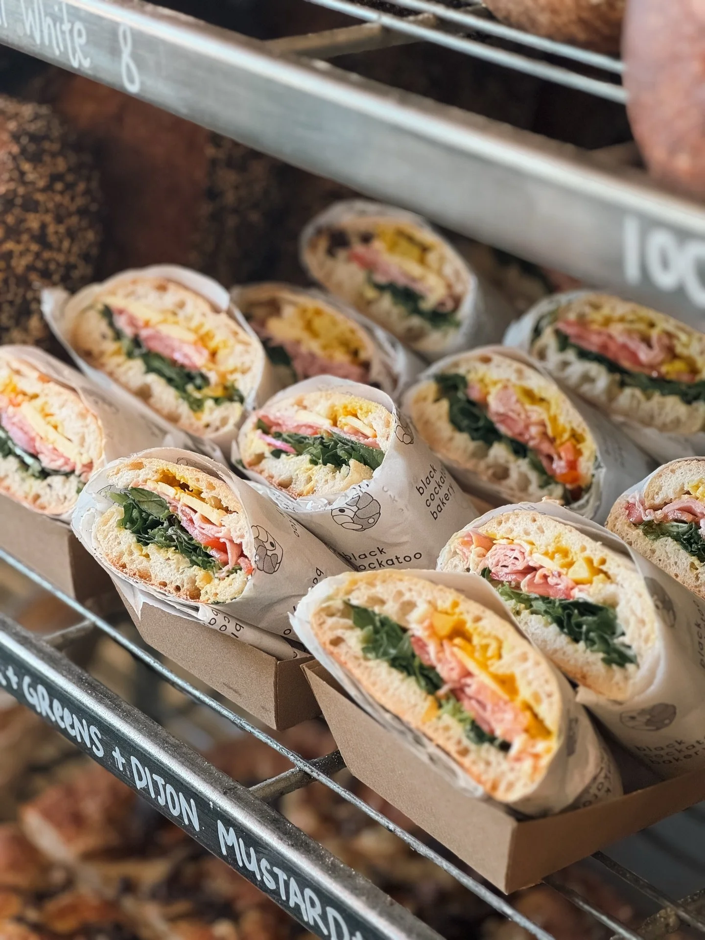 Fresh gourmet sandwiches at Black Cockatoo Bakery filled with greens, cheese and cured meats