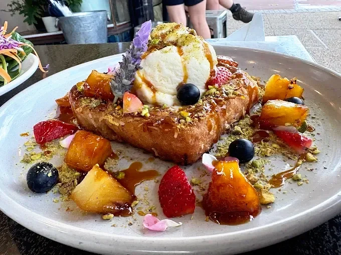 Gourmet French toast with ice cream, caramelised fruit and pistachio crumble