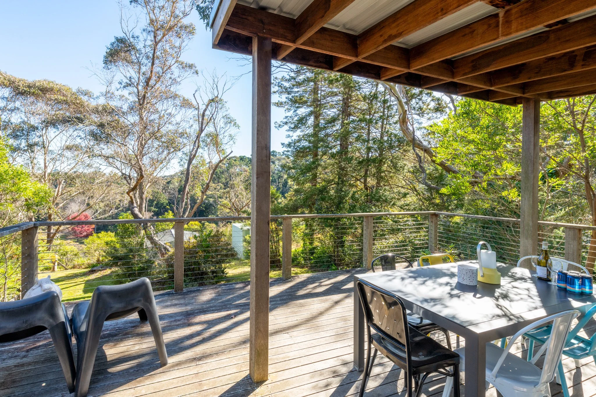 Outdoor deck in Katoomba, Blue Mountains featuring dining area, timber decking and scenic native bushland outlook.