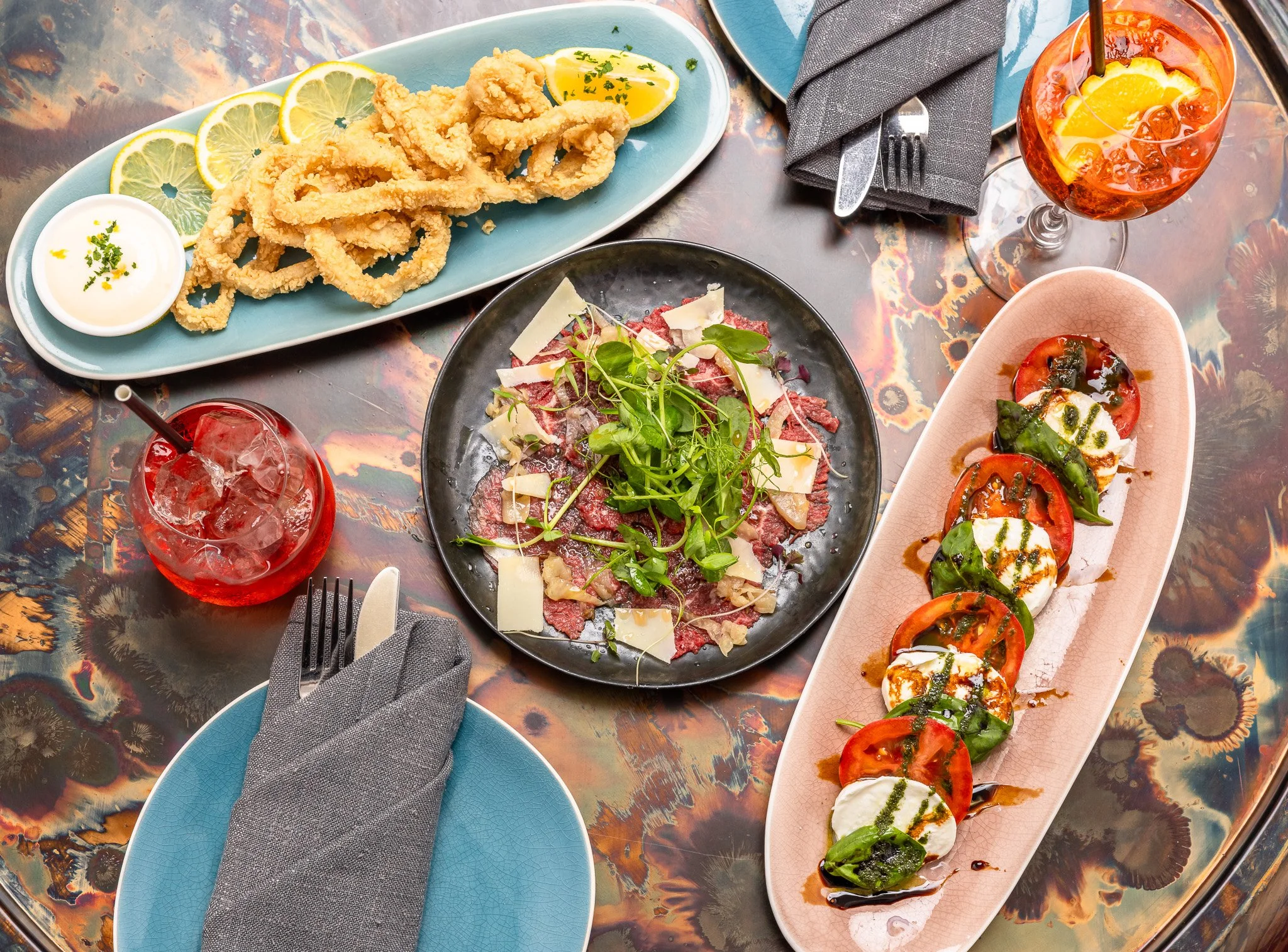Italian dishes including calamari, carpaccio, and caprese salad served at Osteria 2785 Blackheath