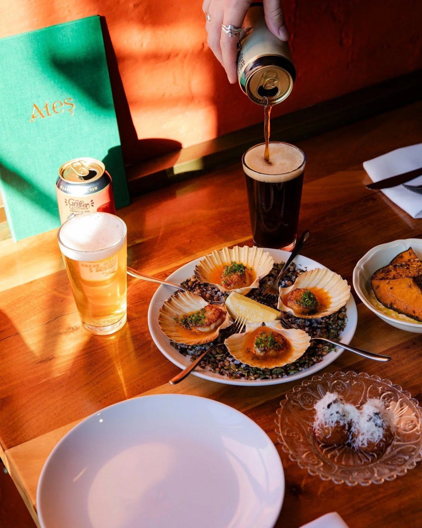 Pouring craft beer at Ates Blackheath with seafood dishes and restaurant setting