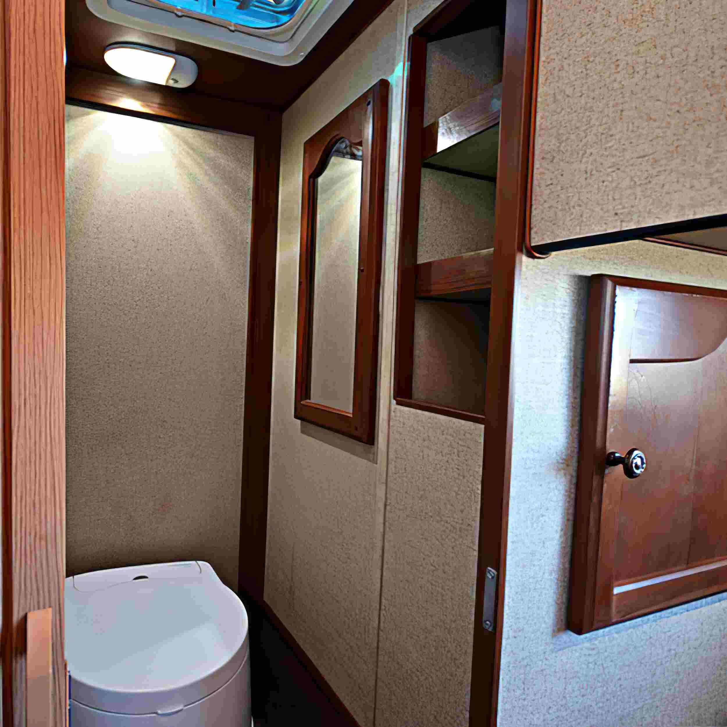  Beautiful woodgrain veneers give the Backpacker 2 rustic appeal, and there is a private interior area with a door and removable toilet. 