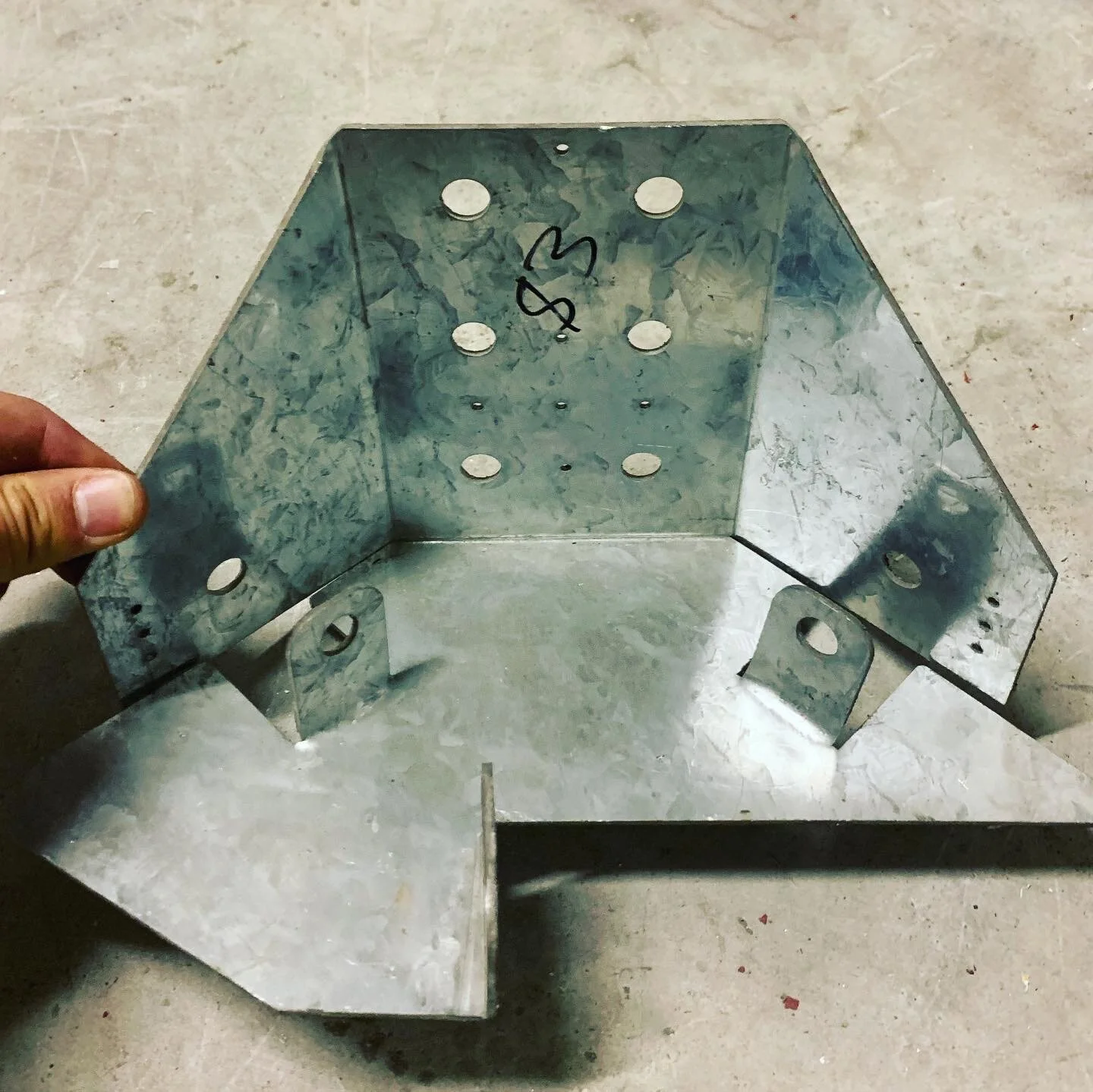 Metal bracket with holes on. Three way truss hanger