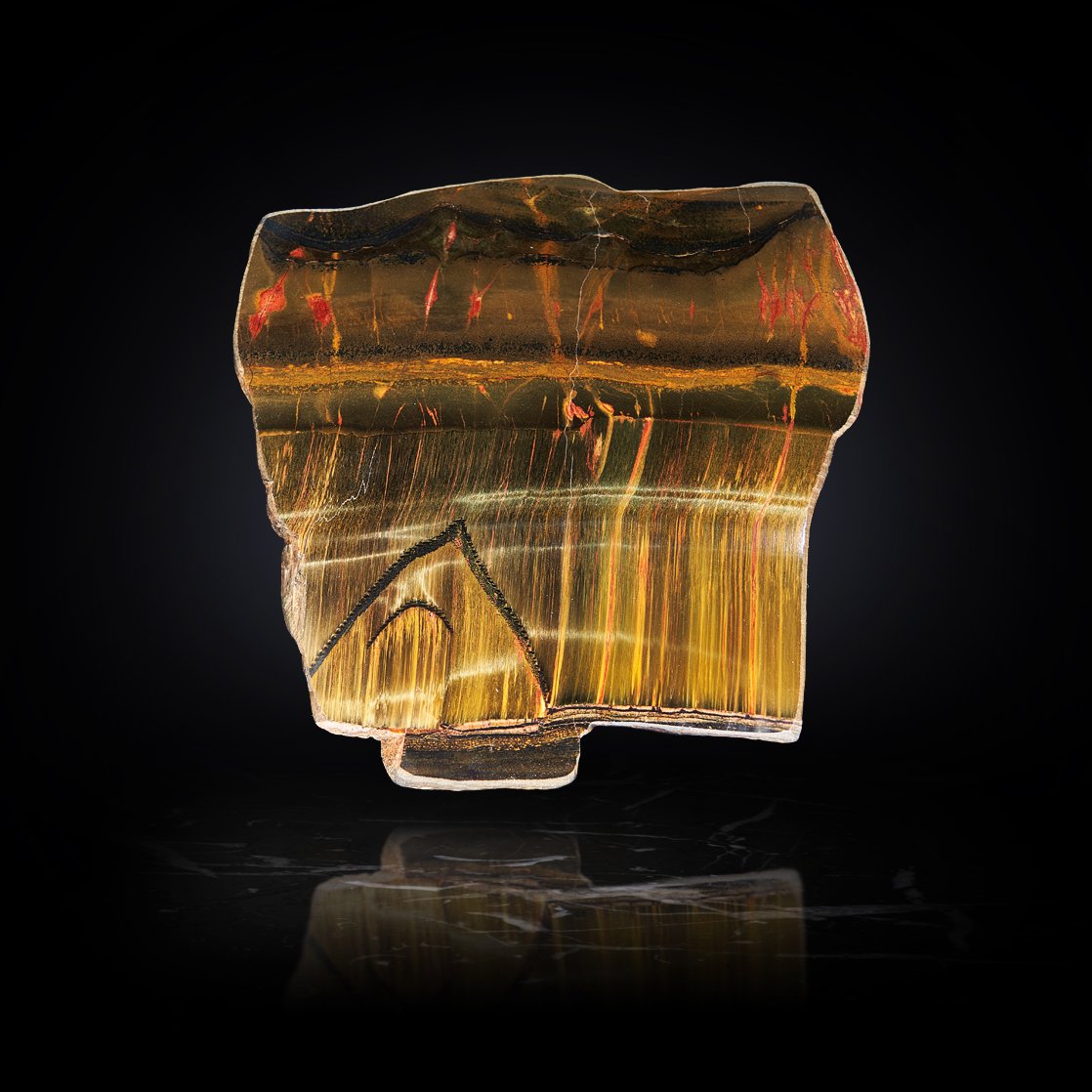 Image Description: A Marra Mamba slab showcasing fiery colors and a golden chatoyance due to the interplay of quartz and iron oxide.