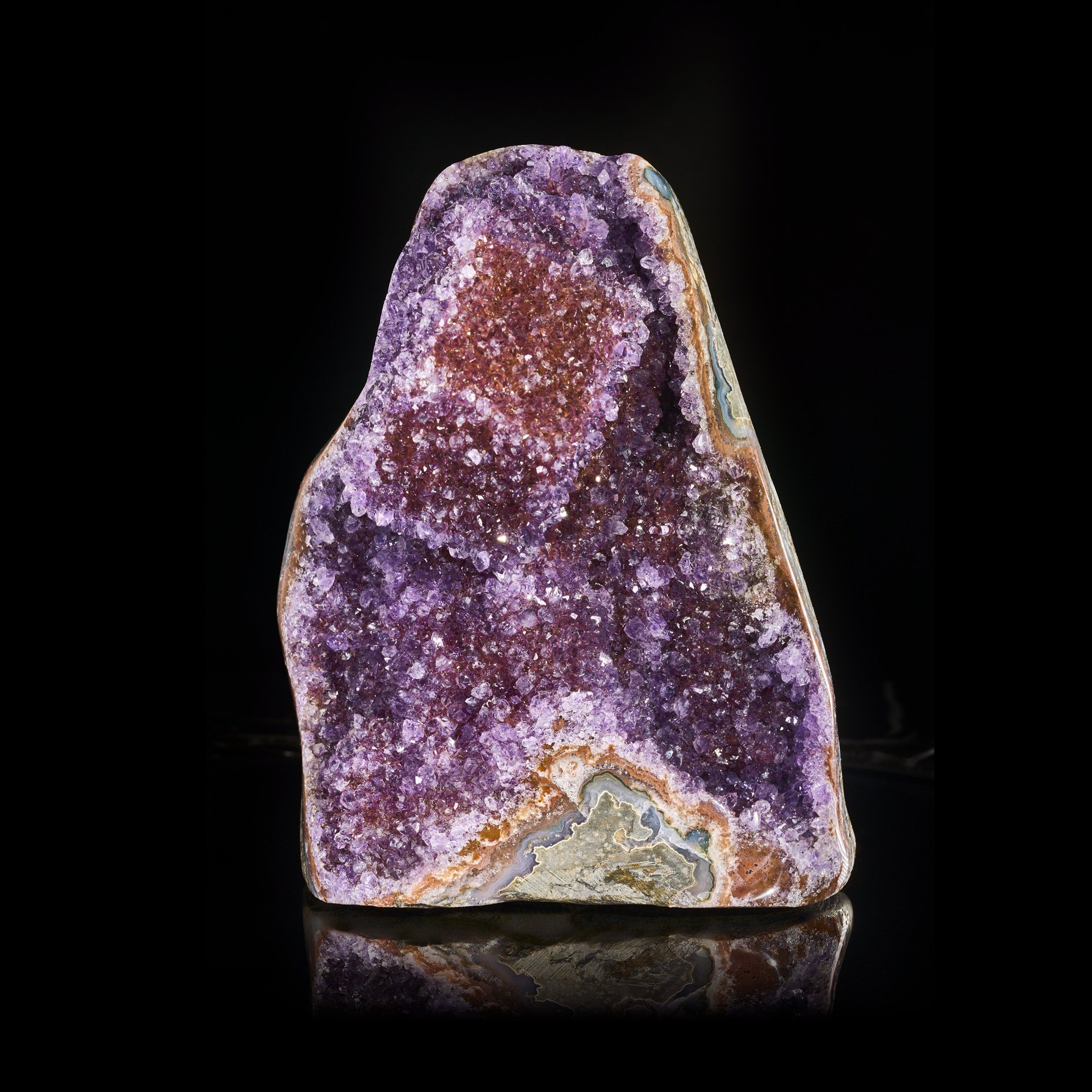 Image Description: A front angle view of a purple amethyst freeform piece with a cubic calcite formation.