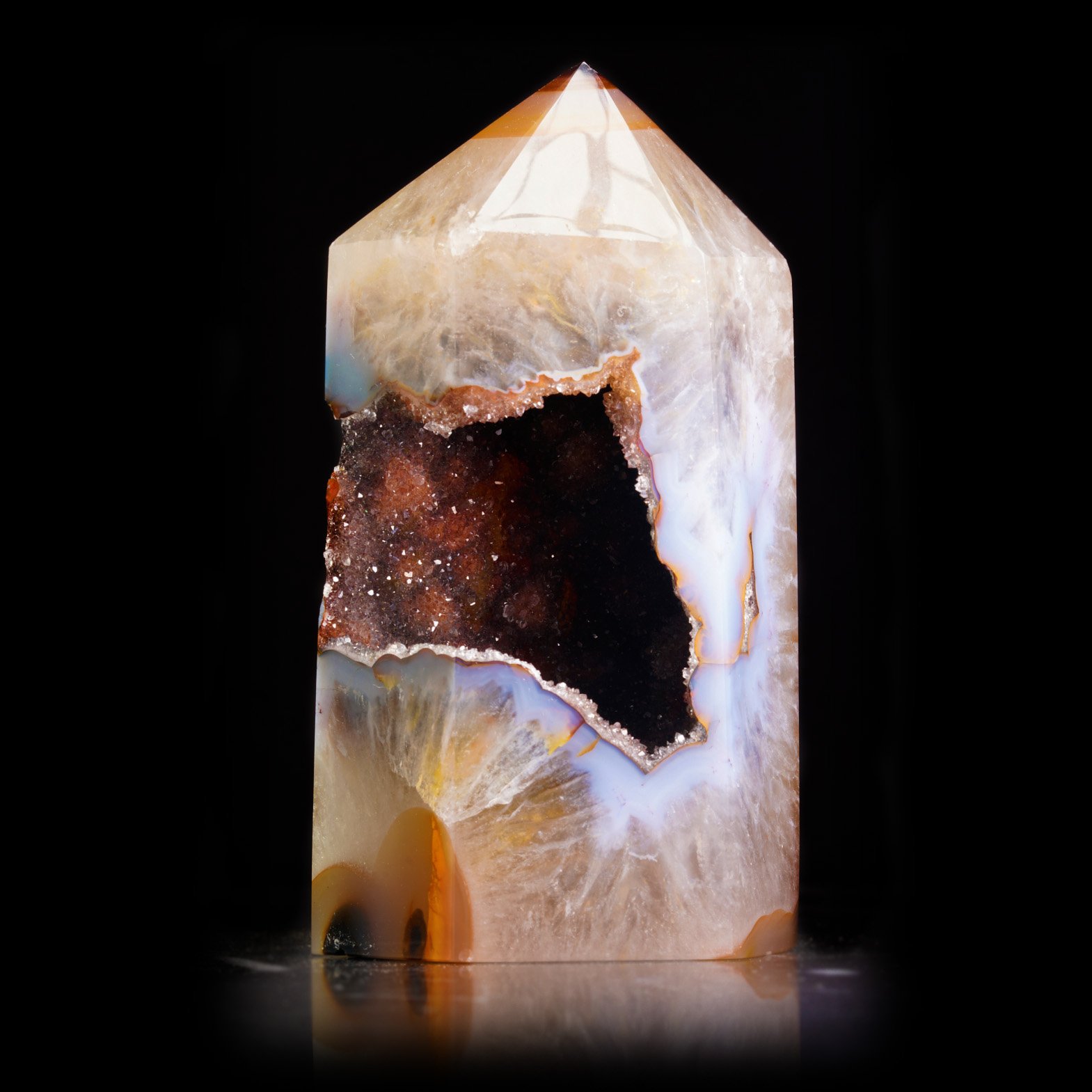 A multicolored agate prism with red amethyst inside.