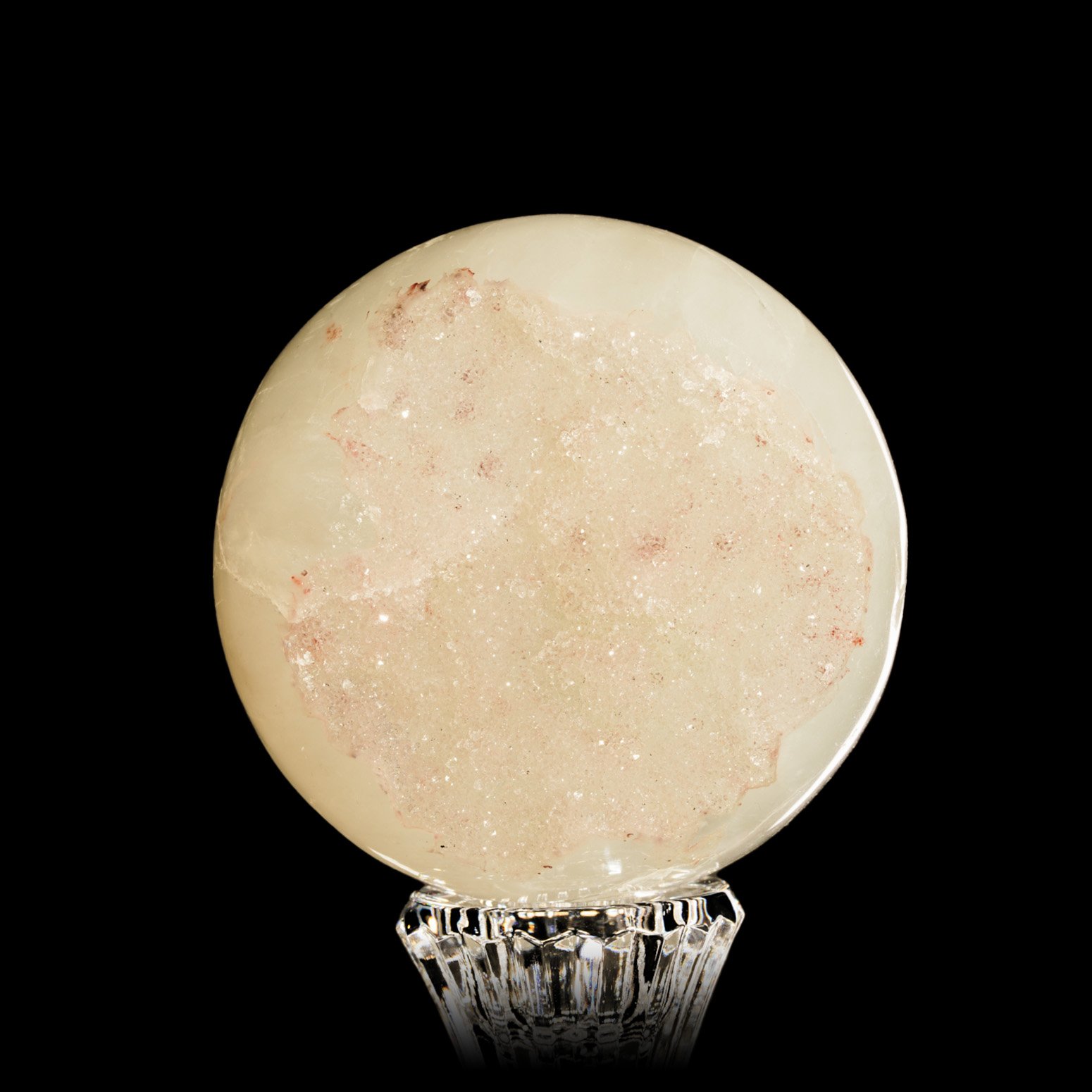An alternate front view of a polished White Galaxy Amethyst Sphere with an open section displaying druse.