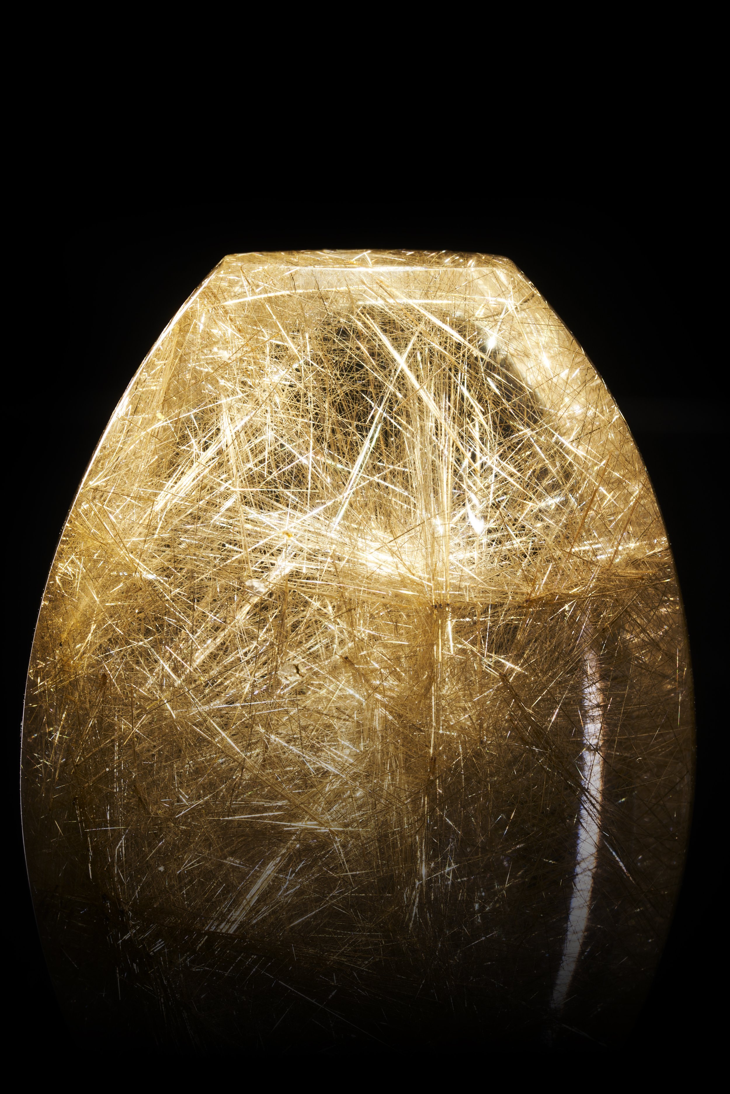 A close-up shot of a Rutilated Quartz Freeform with golden rutile needles, and with flat bottom and top ends. Freestanding piece.