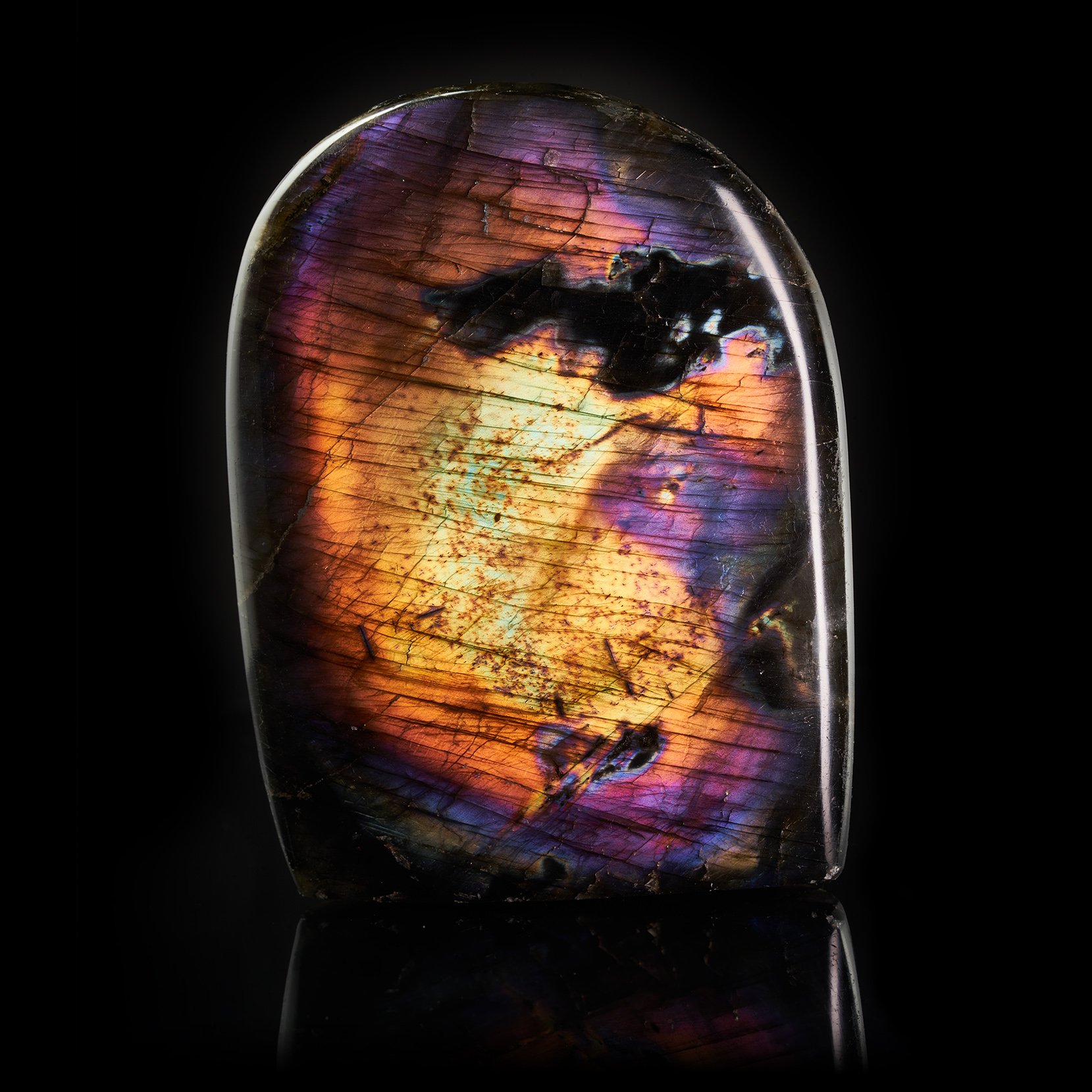 Image Description: A Labradorite Freeform piece with a bright flash of yellow, orange, purple, and blue color hues.