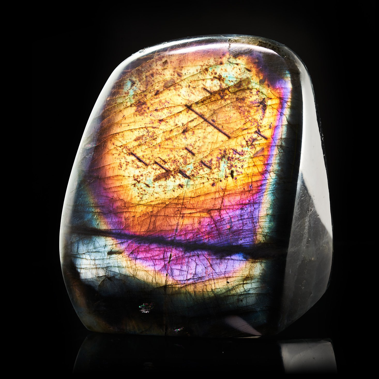Image Description: A Labradorite Freeform piece with a bright flash of yellow, orange, purple, and magenta color hues.