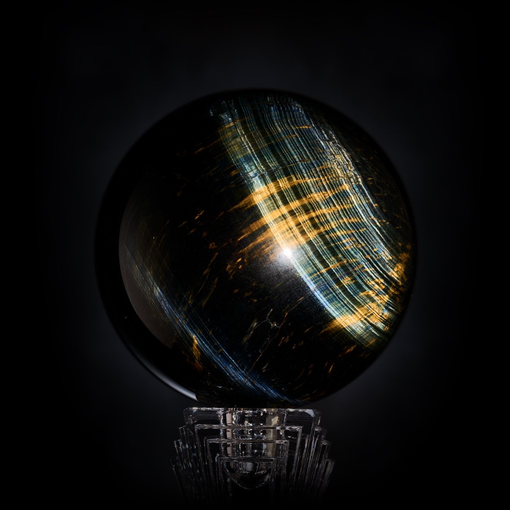 Image Description: A Tiger's Eye sphere with golden orange patterns and impressive blue flashes.